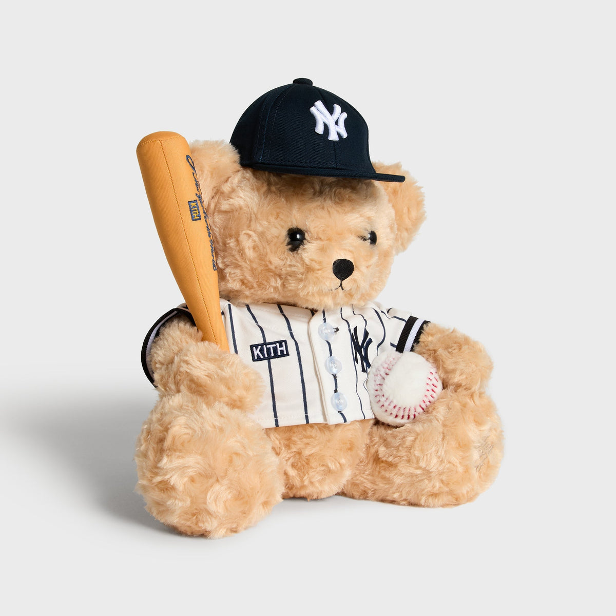 Kith x New York Yankees Teddy Bear in Sandrift, closer front view holding bat and ball