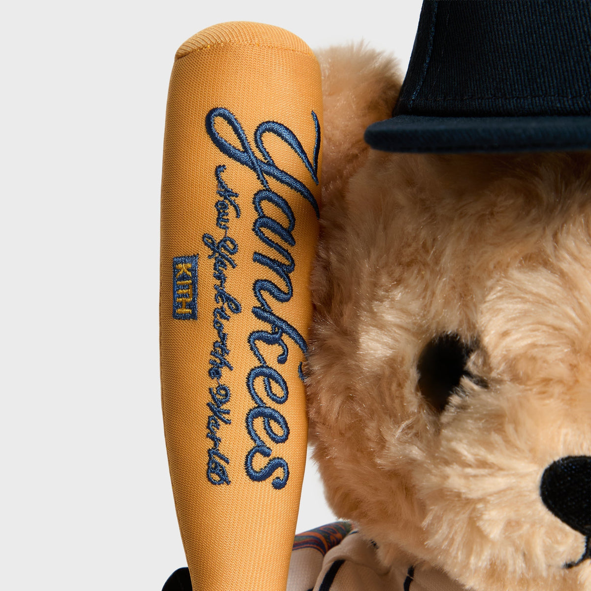 Close-up of Yankees script embroidered on the toy bat handle held by the Sandrift bear