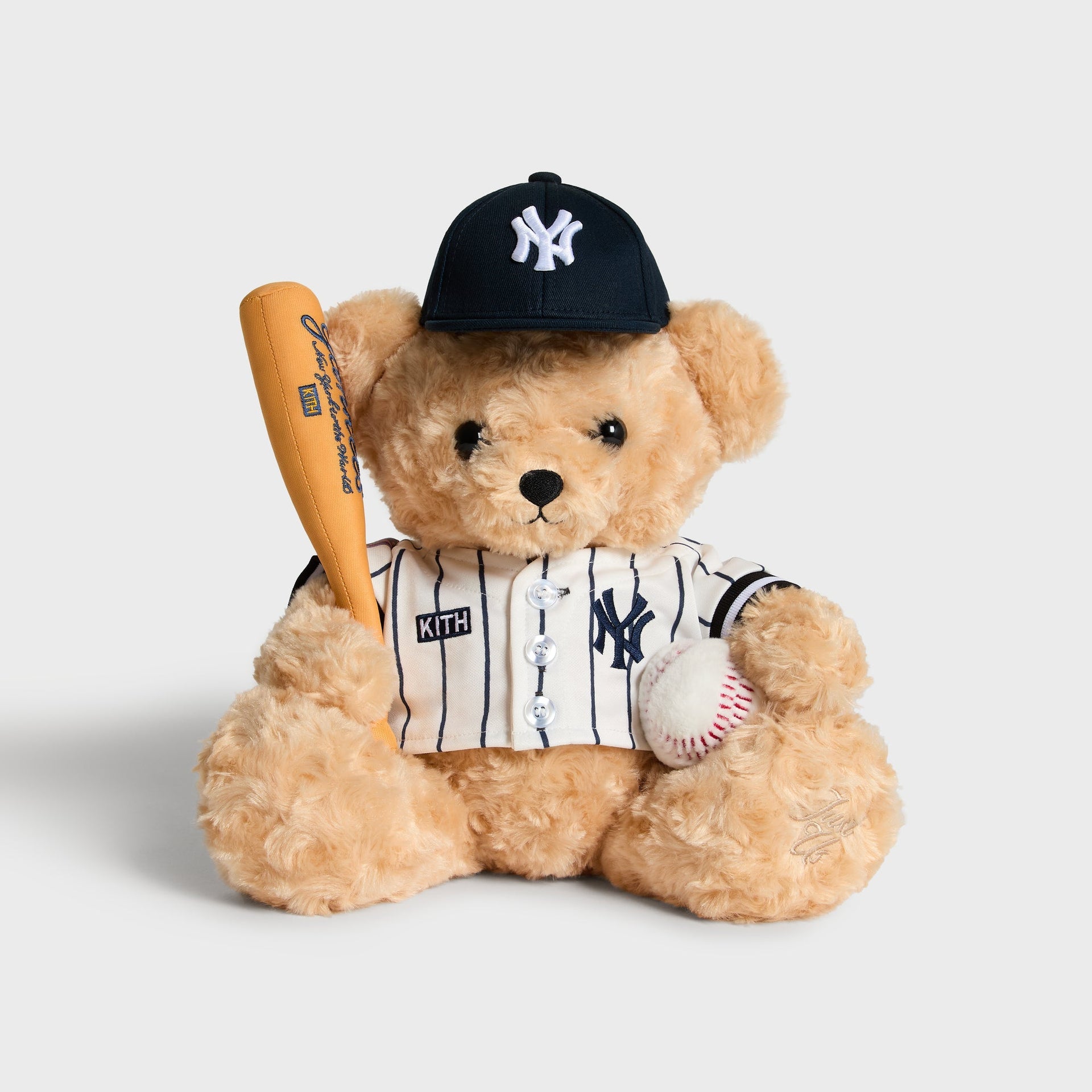 Kith x New York Yankees Teddy Bear in Sandrift, front view holding bat and baseball