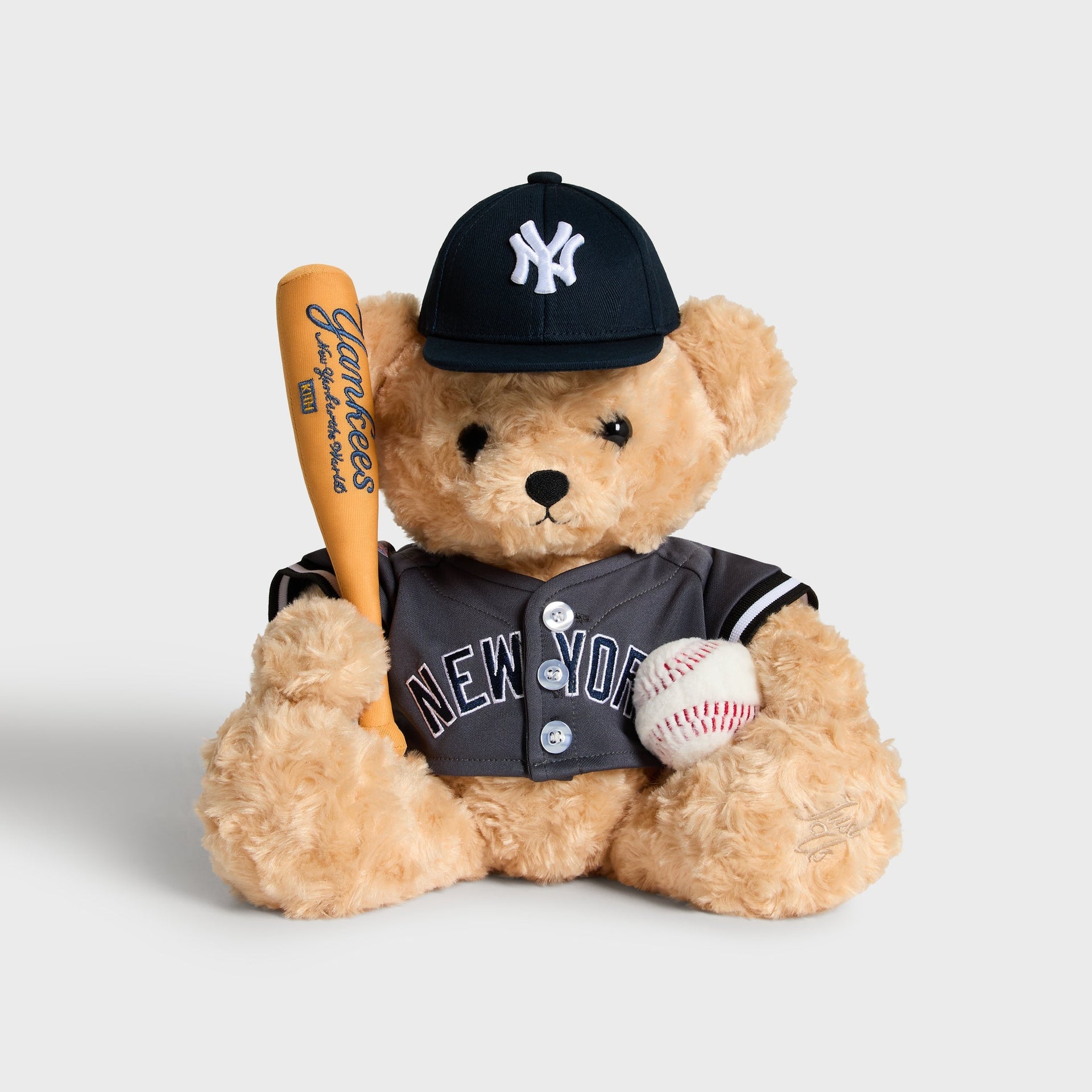 Kith x New York Yankees Teddy Bear in Skyscraper grey, front view holding bat and baseball