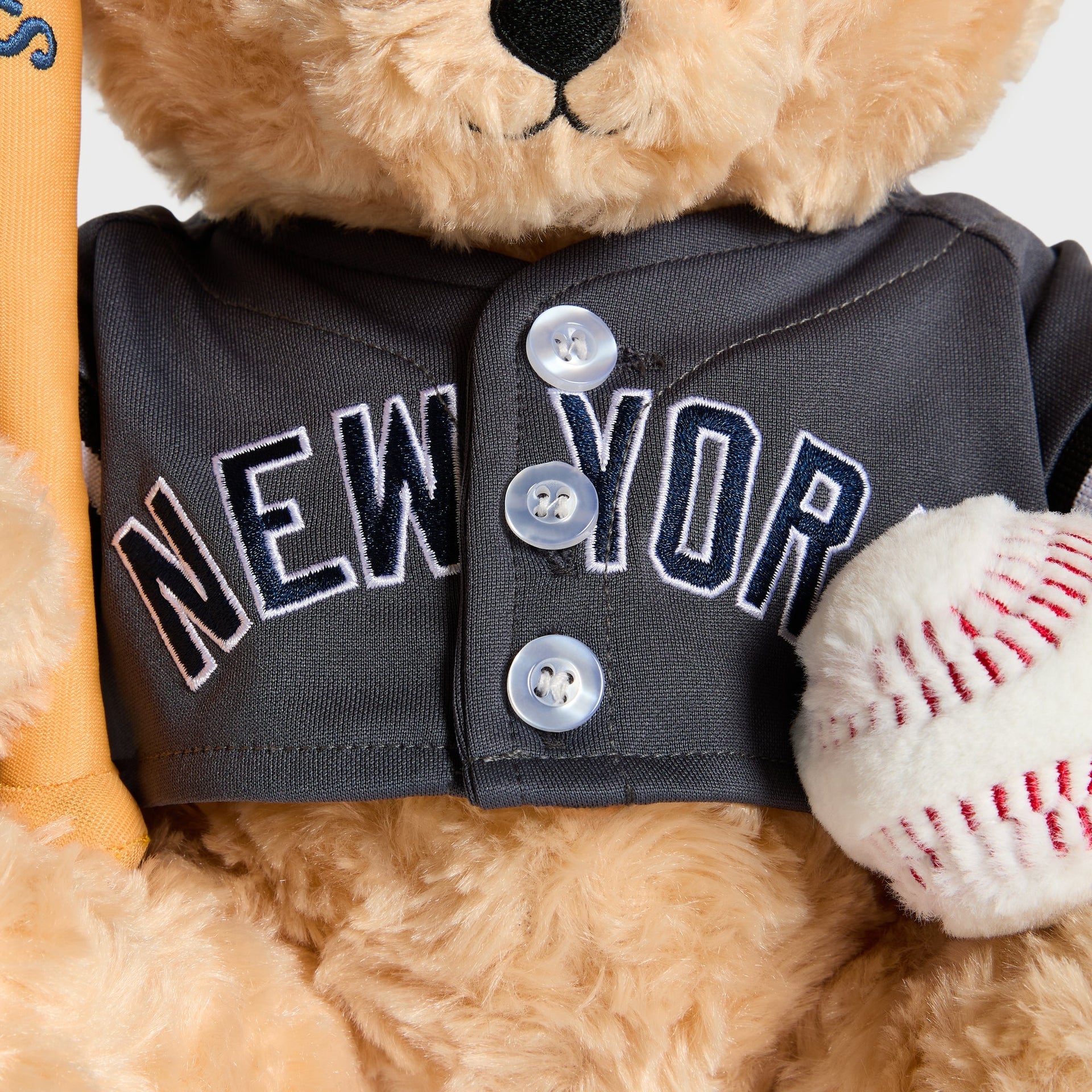 Close-up of grey jersey button placket and NEW YORK lettering on the Skyscraper bear