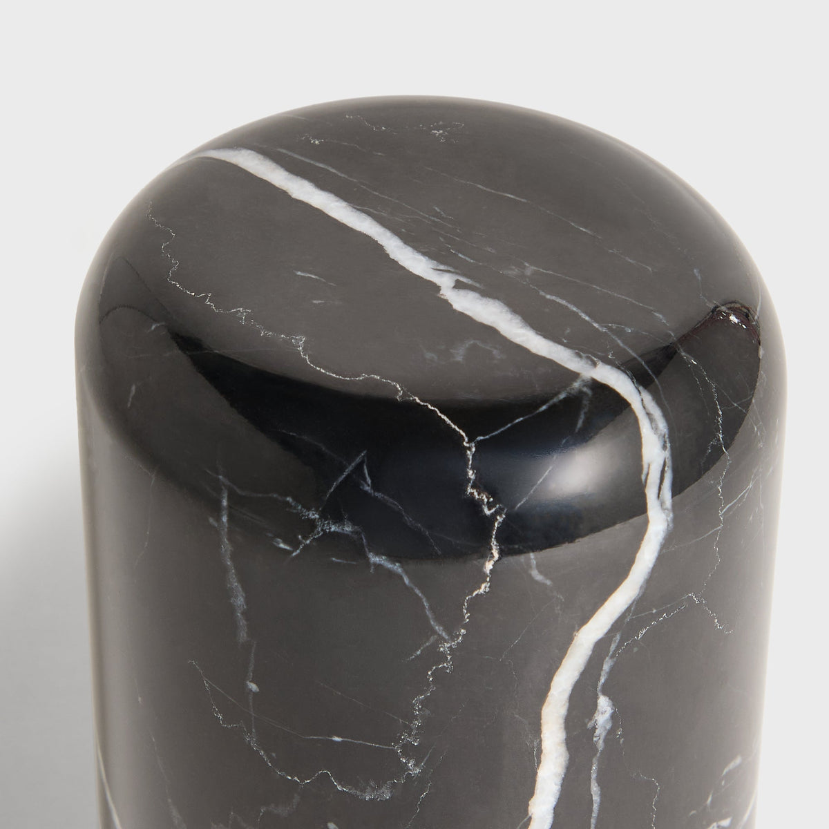 Close-up of rounded base of black Kith marble tumbler with white vein