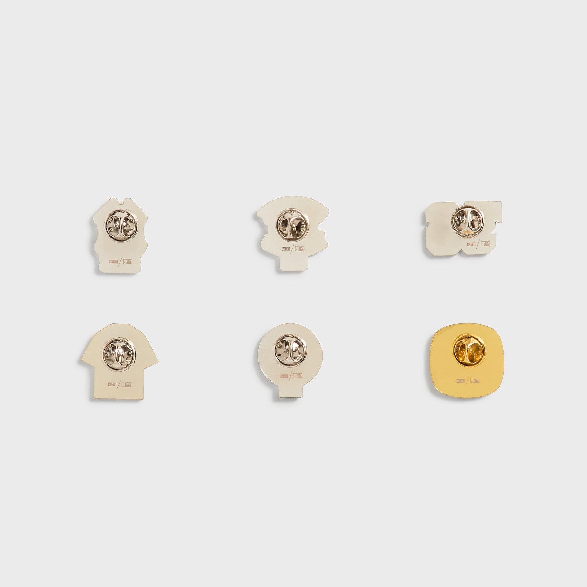 Kith x New York Yankees pin set, back view showing pin posts, clasps, and MLB stamp