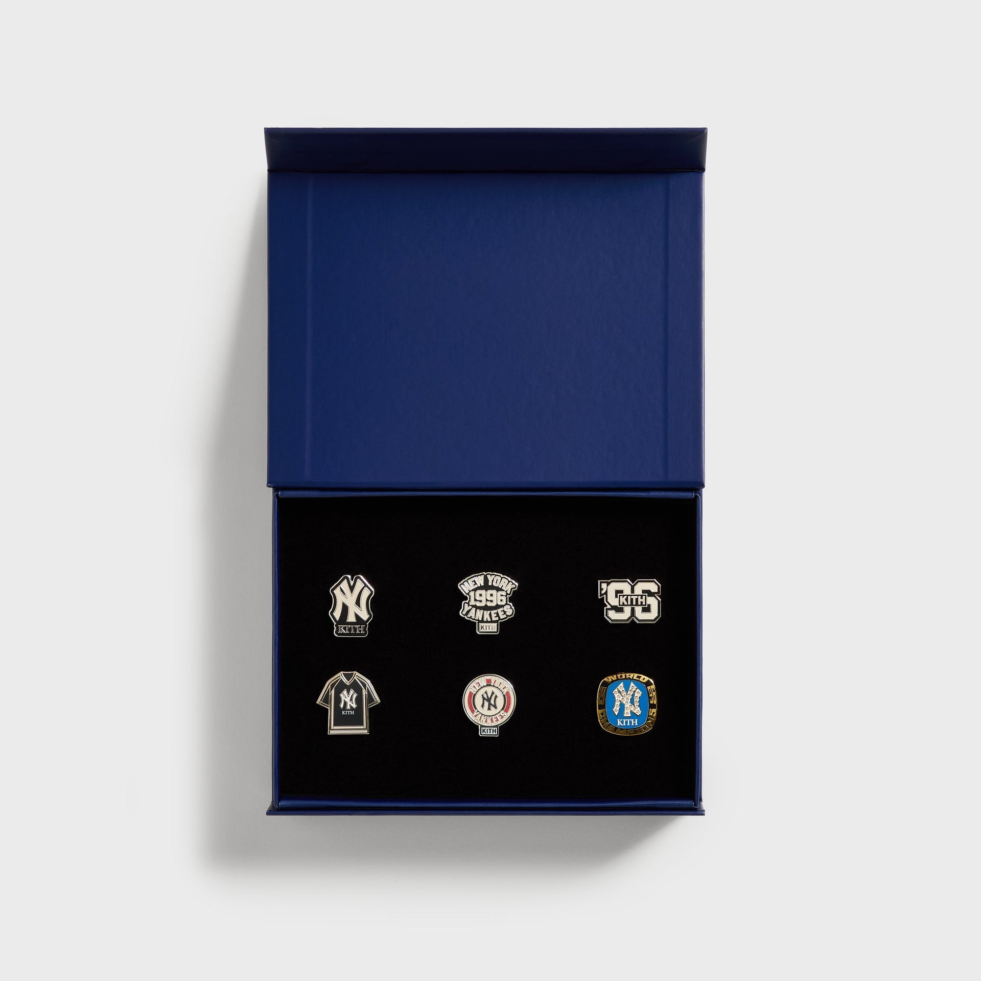 Kith x New York Yankees pin set, top-down view inside the open navy gift box