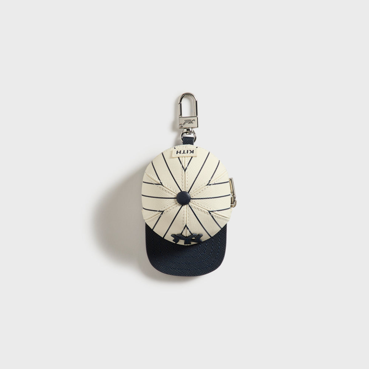 Kith x Yankees Baseball Cap Leather Pouch, Sandrift - front view, cream pinstripe cap shape with navy brim