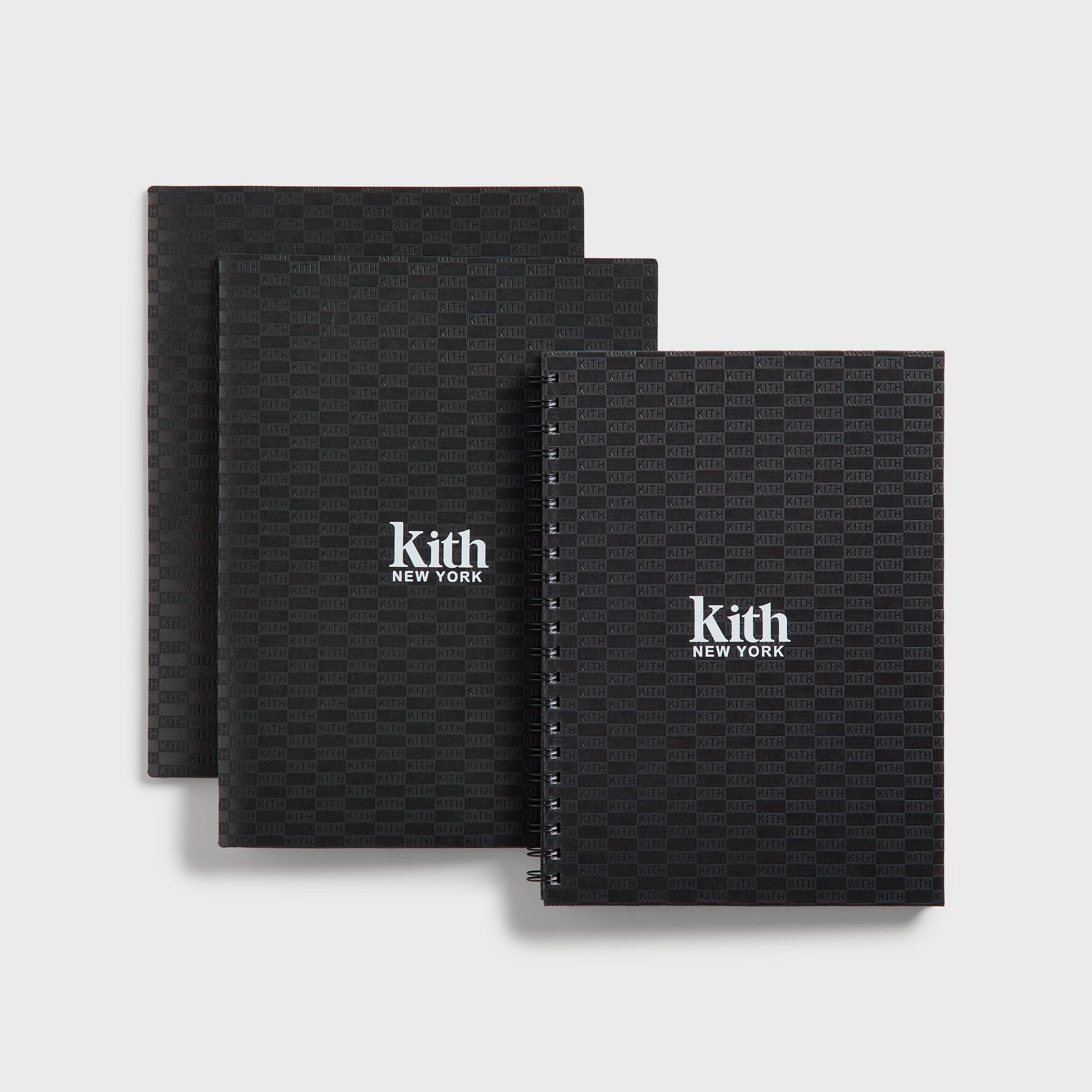 Kith Kids School Supplies Box Set in black, three notebooks and folders with tonal monogram print and white Kith New York logo