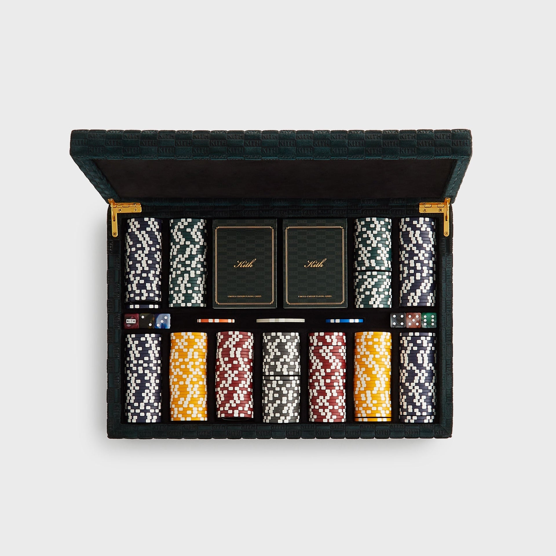 Overhead of the open Kith Poker Set: navy, green, yellow, red and grey crown chips, twin Kith card decks and marbled dice