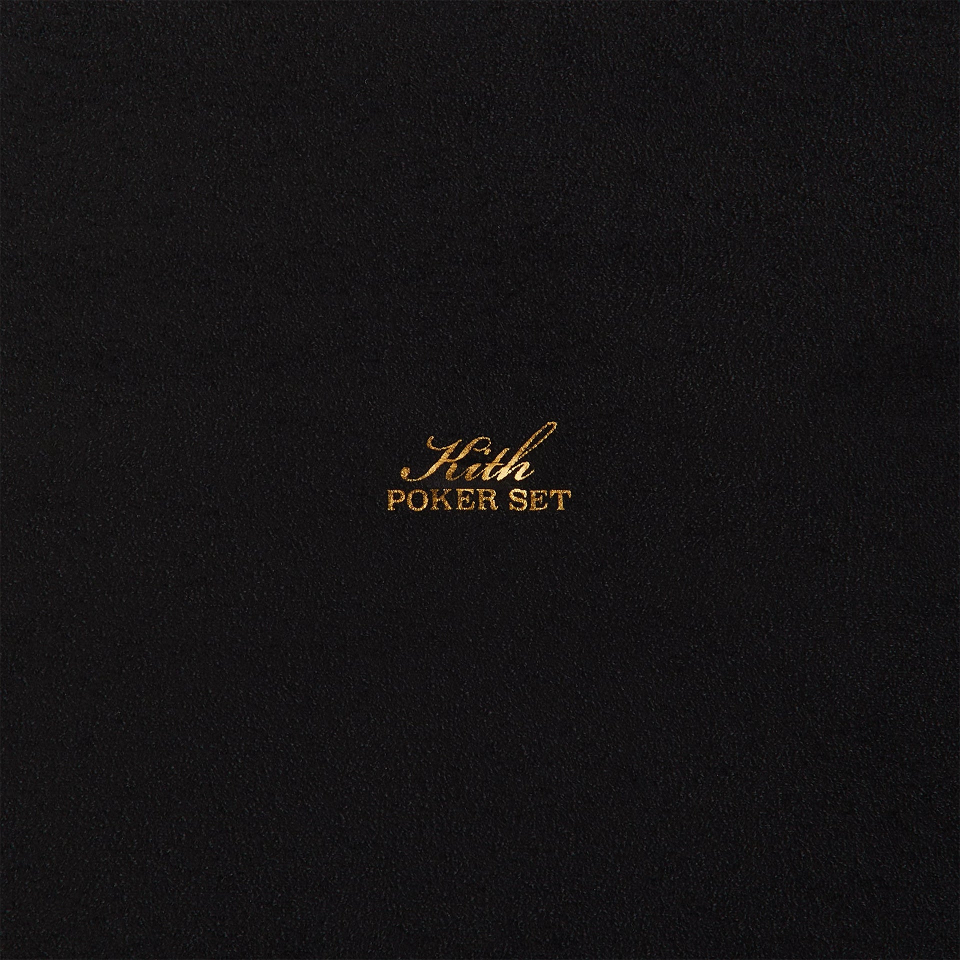 Black suede interior lid of the Kith Poker Set with gold-foil Kith Poker Set script, macro detail