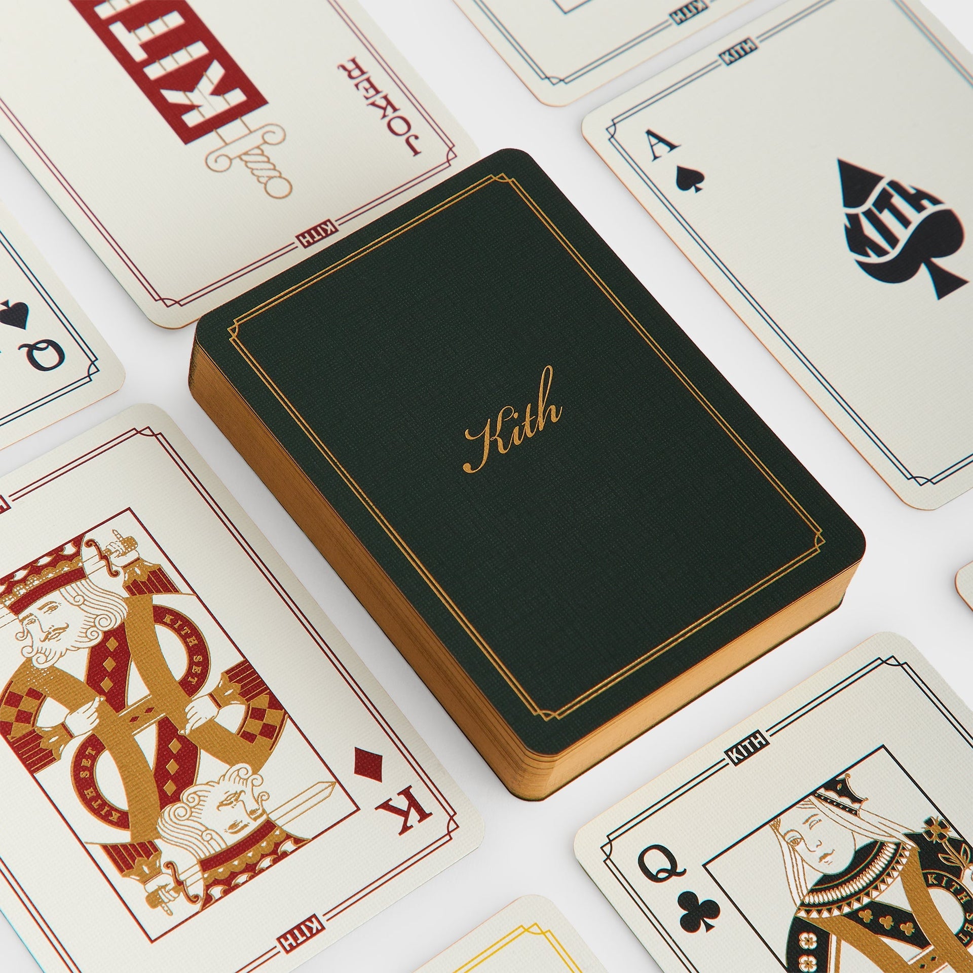 Kith Limited Edition playing cards, gilt-edged deck with green Kith script back fanned with the Ace of Spades and court cards