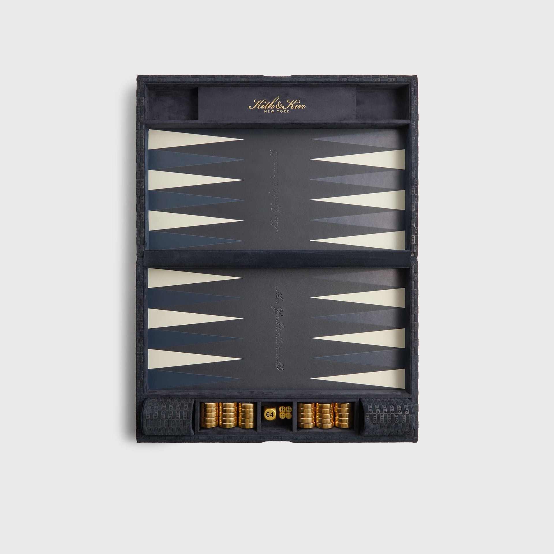 Kith & Kin backgammon set open flat, ink suede case with grey, navy and cream points, gold checkers, dice and 64 doubling cube