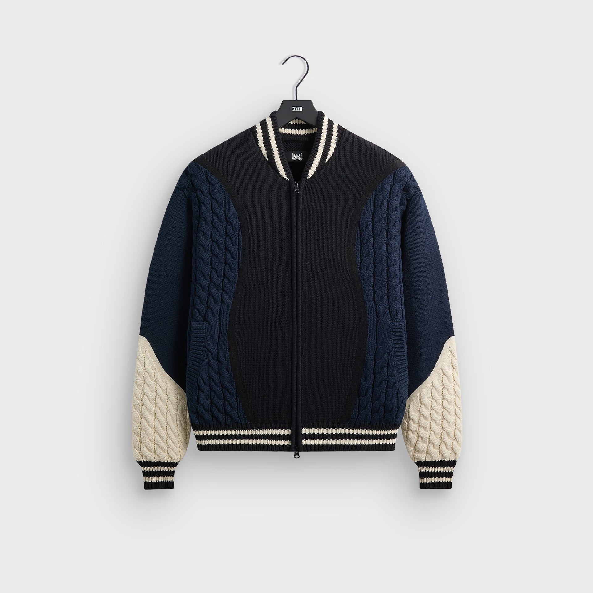 Kith for Needles Wyona full zip sweater in black and navy with cream cable-knit sleeves, front flat lay