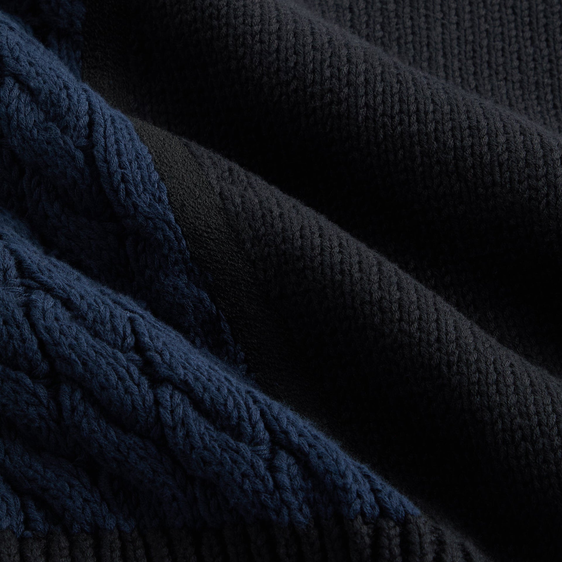 Close-up of the navy cable knit sleeve texture on the Kith for Needles Wyona full zip sweater