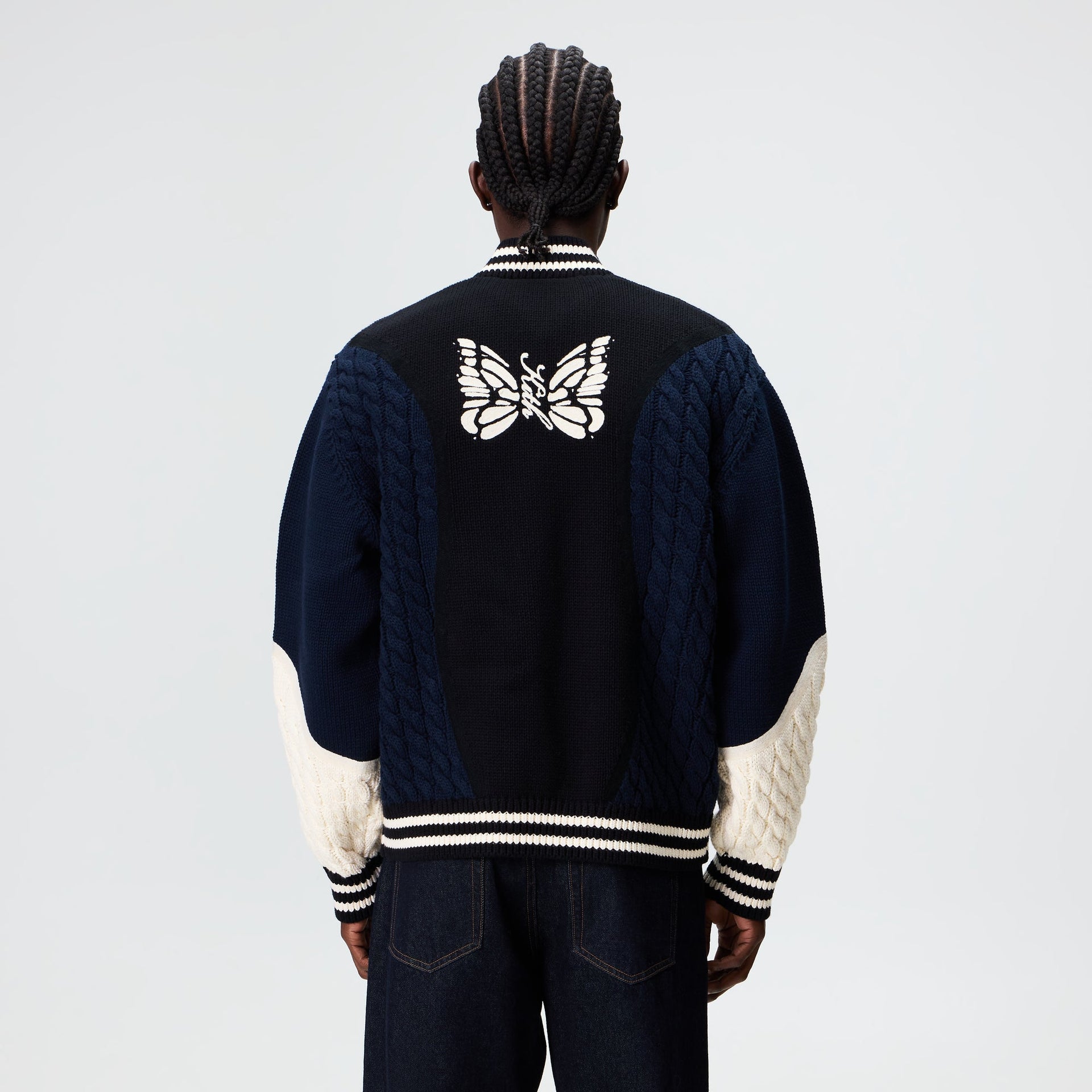 Man wearing the Kith for Needles Wyona full zip sweater, back view showing cream butterfly knit graphic