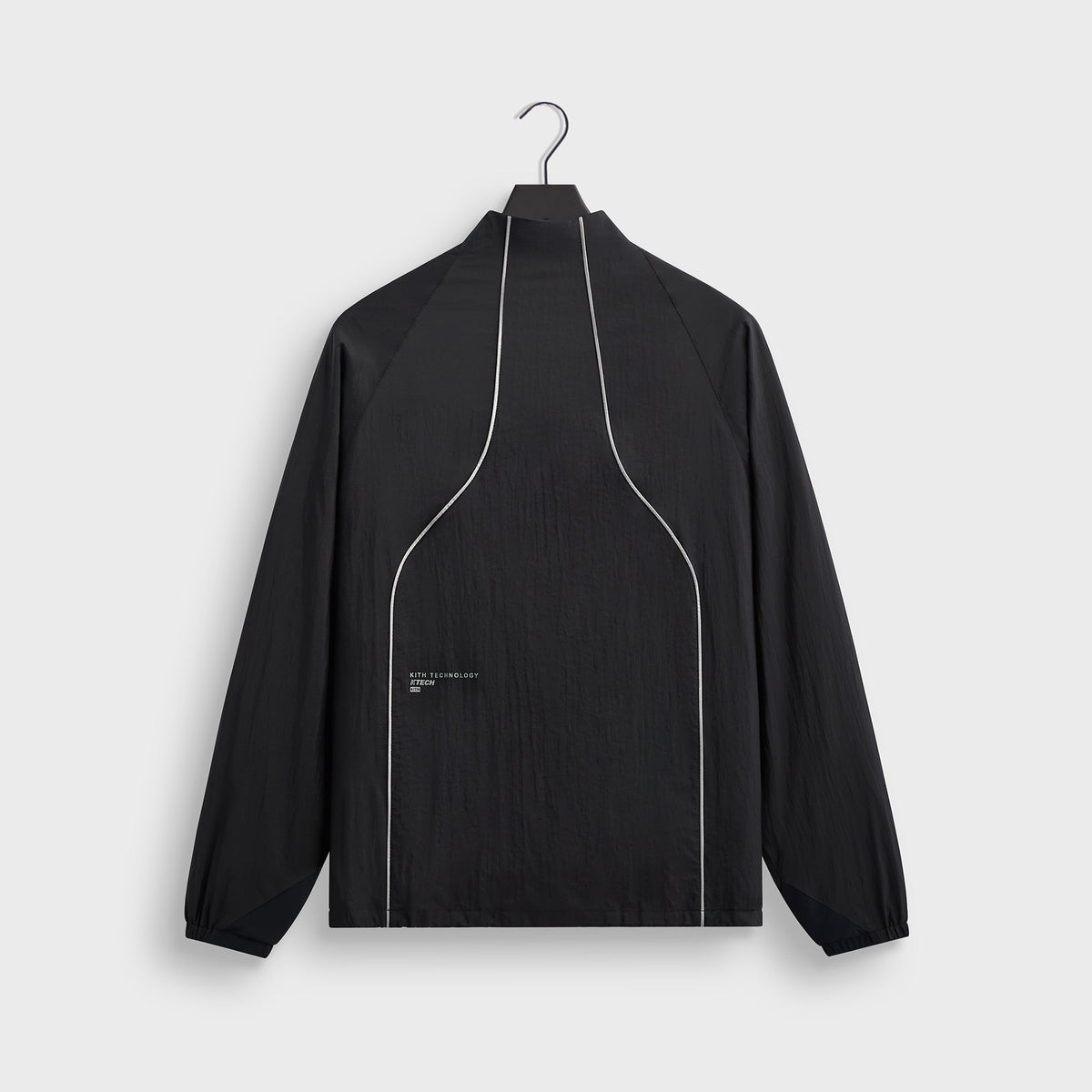 Close-up of Kith Eryx Track Jacket zip pull and KTECH wordmark at the collar
