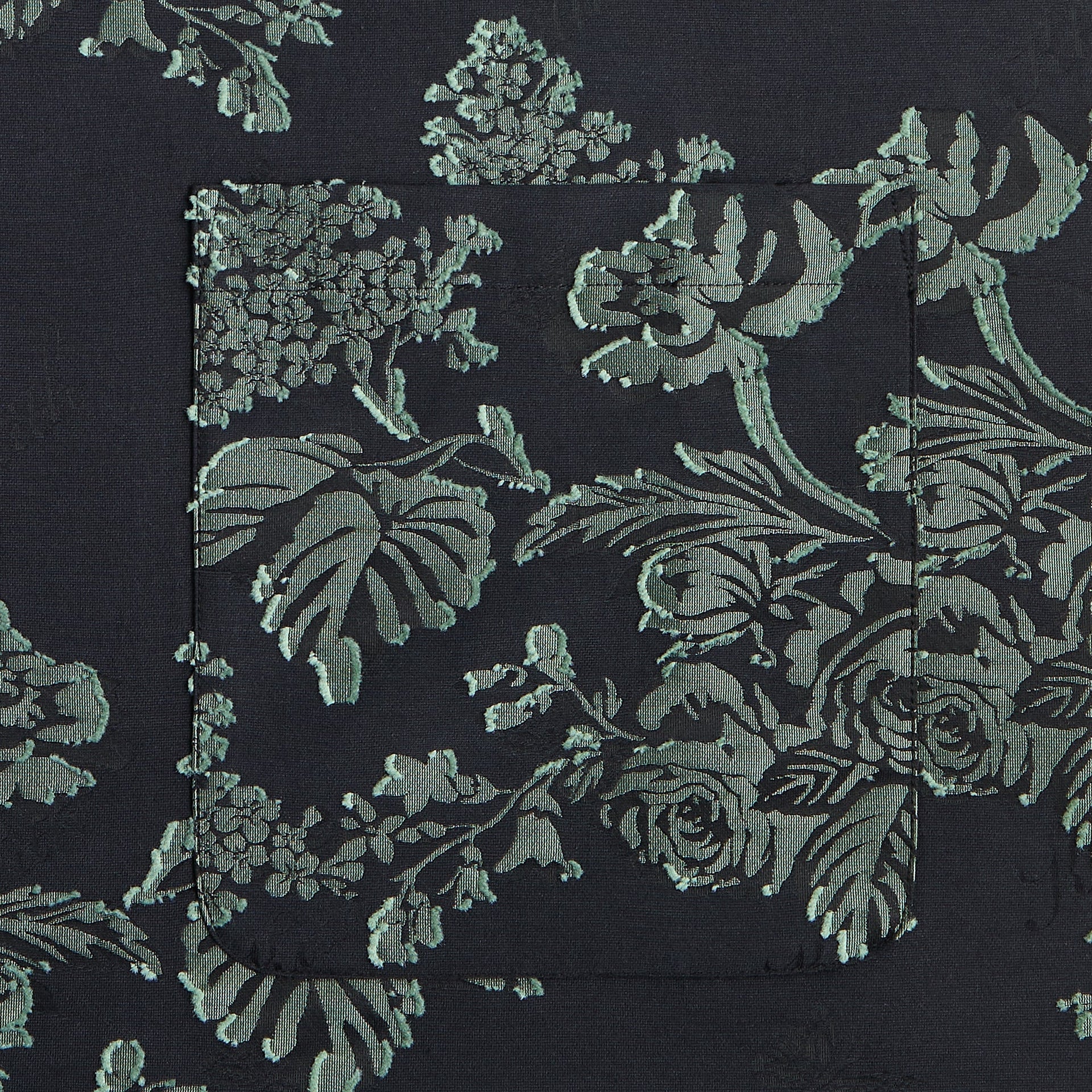 Close-up of the chest pocket on the Kith for Needles BCO shirt in black floral jacquard