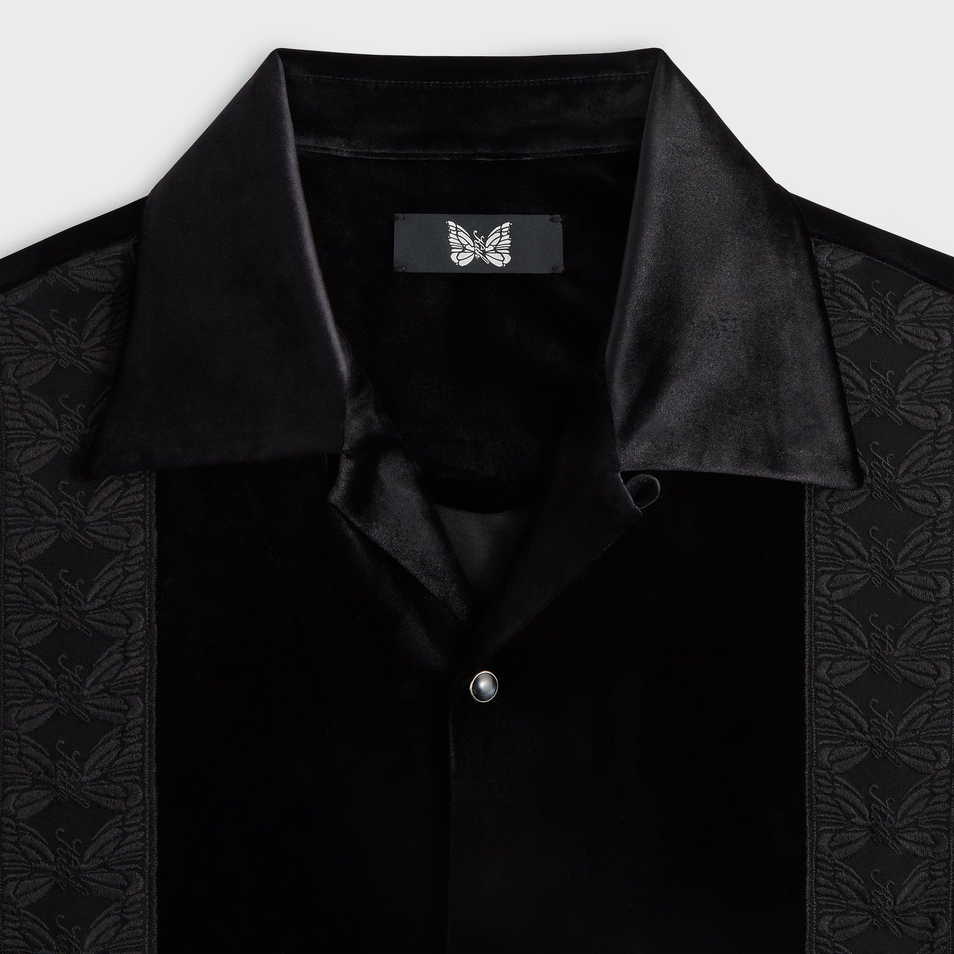 Close-up of the camp collar and woven butterfly label on the Kith for Needles Ren fringe shirt