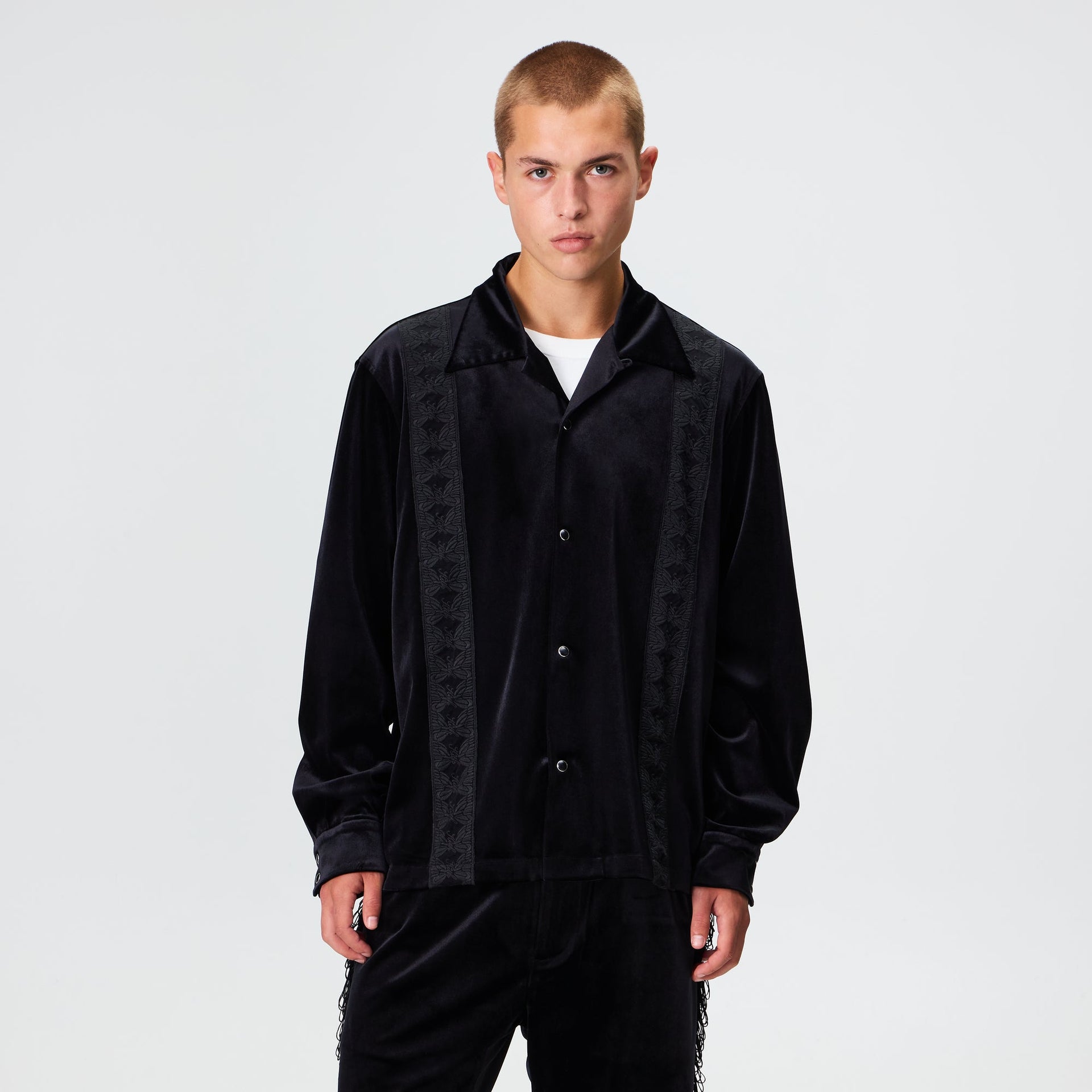 Man wearing the Kith for Needles Ren fringe camp collar shirt in black velour, front view