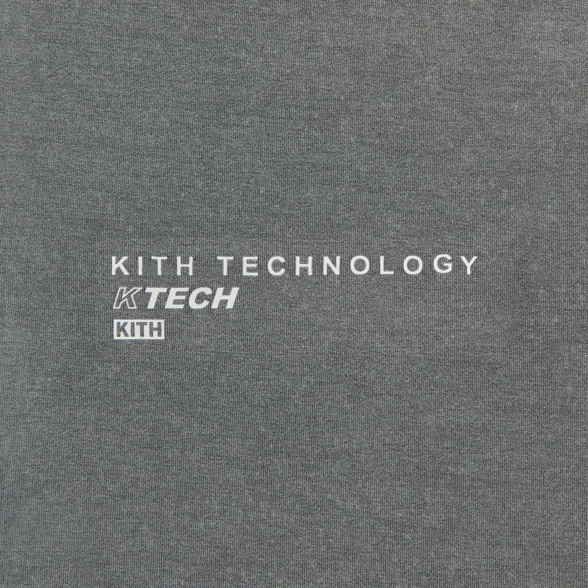 Close-up of Kith Garment-Dyed Heathrow Tee back hem reading Kith Technology KTECH