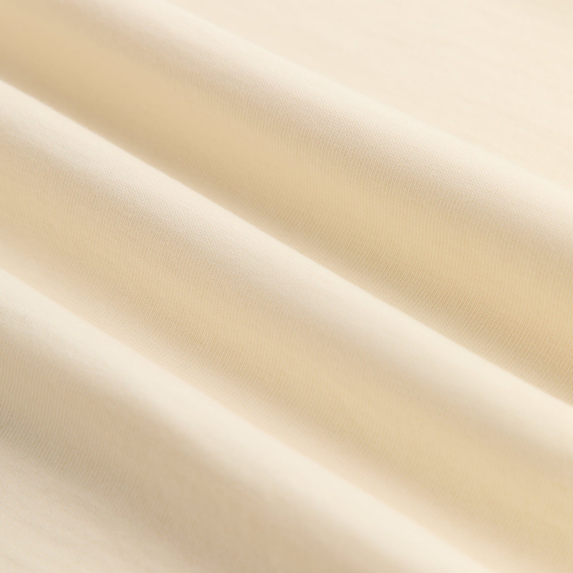 Close-up of soft cream Sandrift cotton fabric texture of Kith for Depeche Mode Vintage Alex Tee