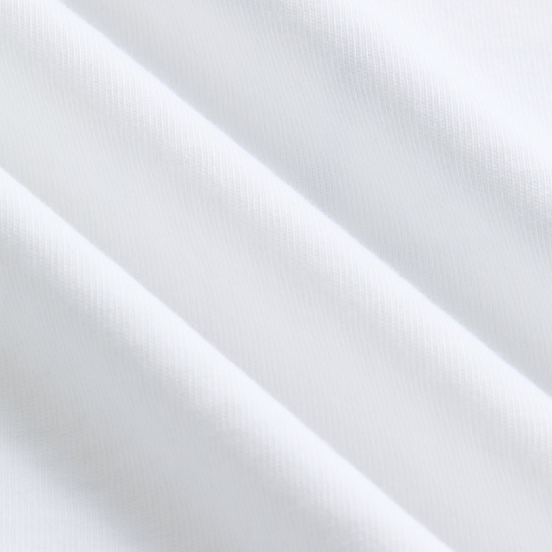 Close-up of white cotton jersey fabric on Kith Records Depeche Mode Vintage Alex Tee