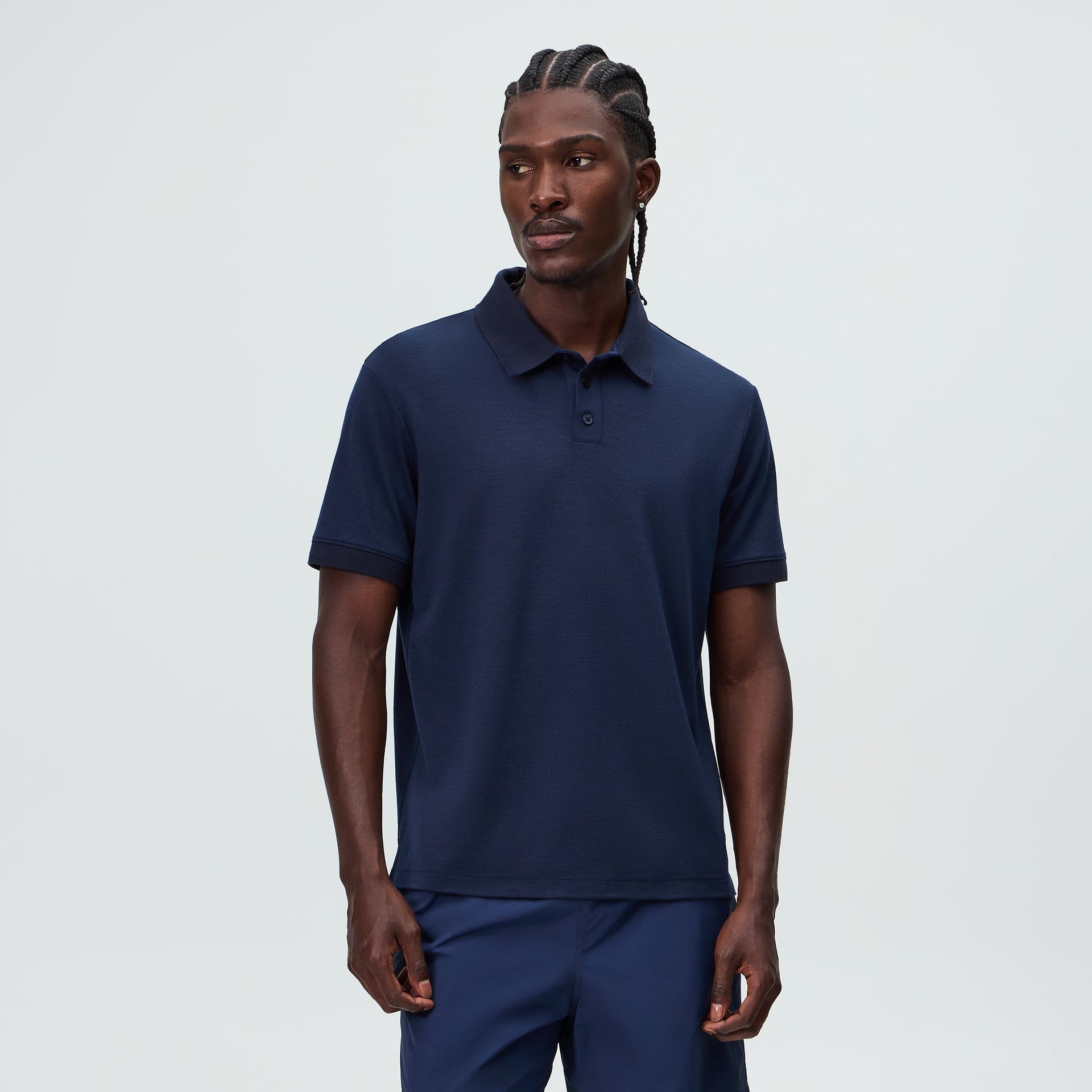&Kin Melton Polo in Nocturnal navy worn by a model, front 3/4 on-body view of the short-sleeve knit polo