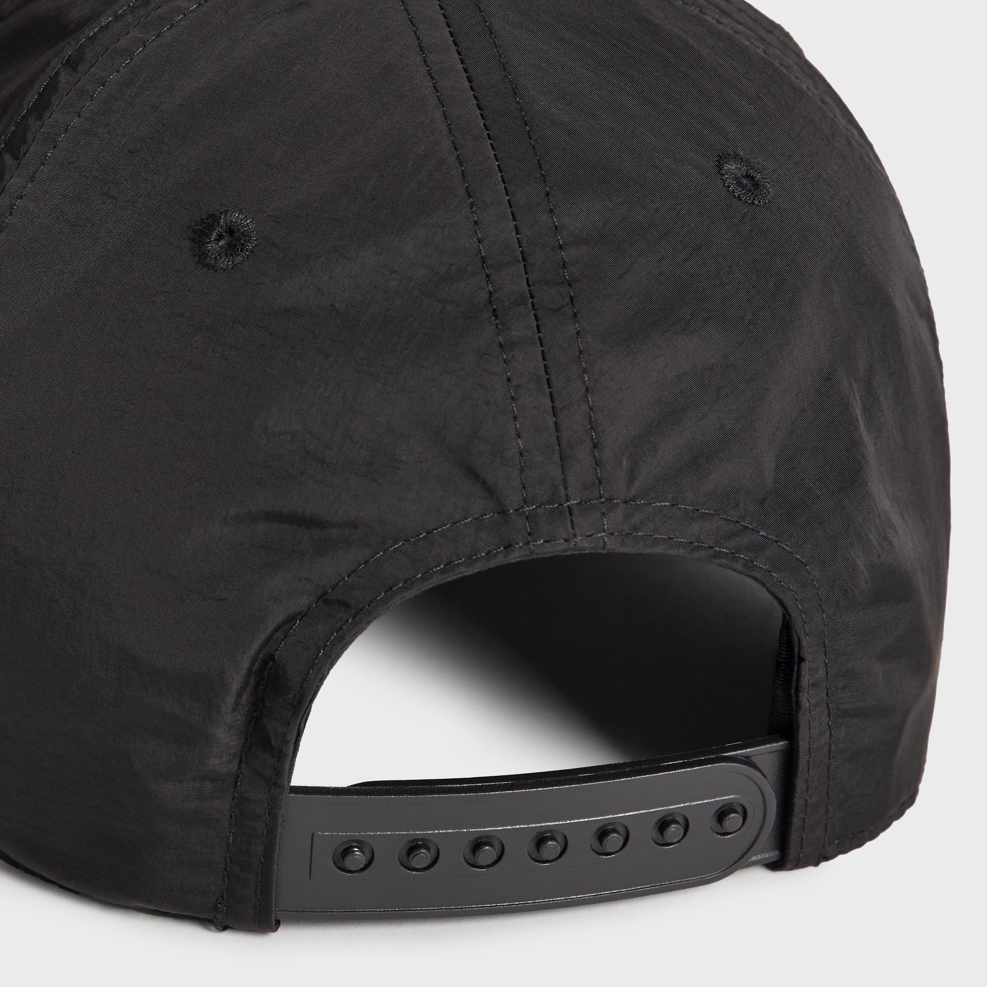 Close-up of the snap closure on the Kith wrinkle nylon Bay low pinch crown snapback