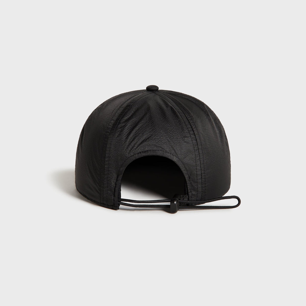 Kith Nylon Ripstop Marathon Cap in black, back view showing the toggle cord closure