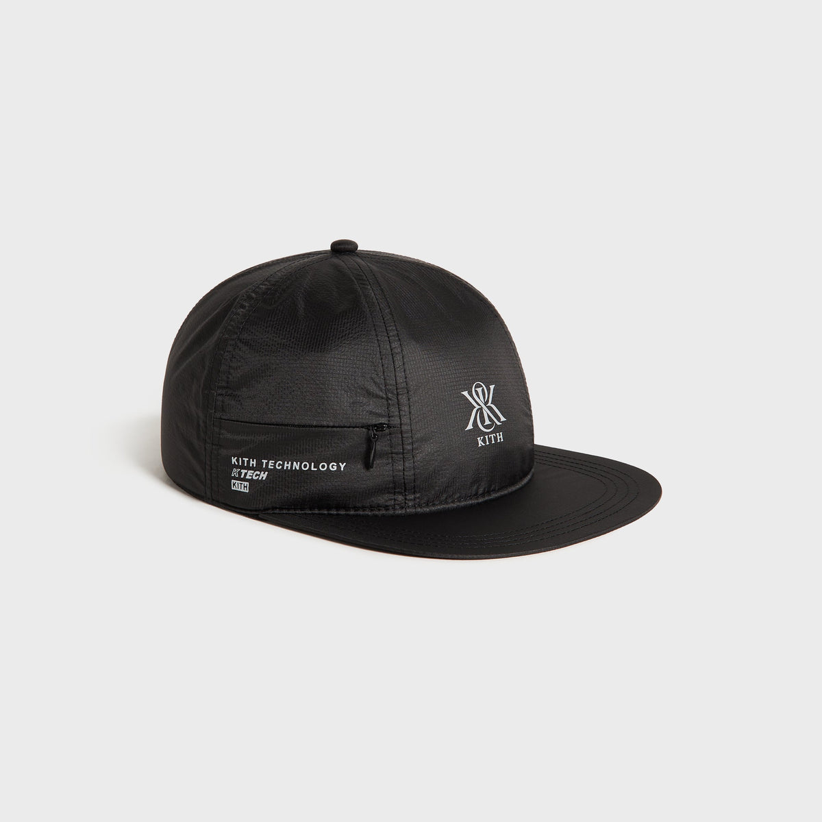 Kith Nylon Ripstop Marathon Cap in black, three-quarter angle showing the ripstop nylon texture and zip pocket