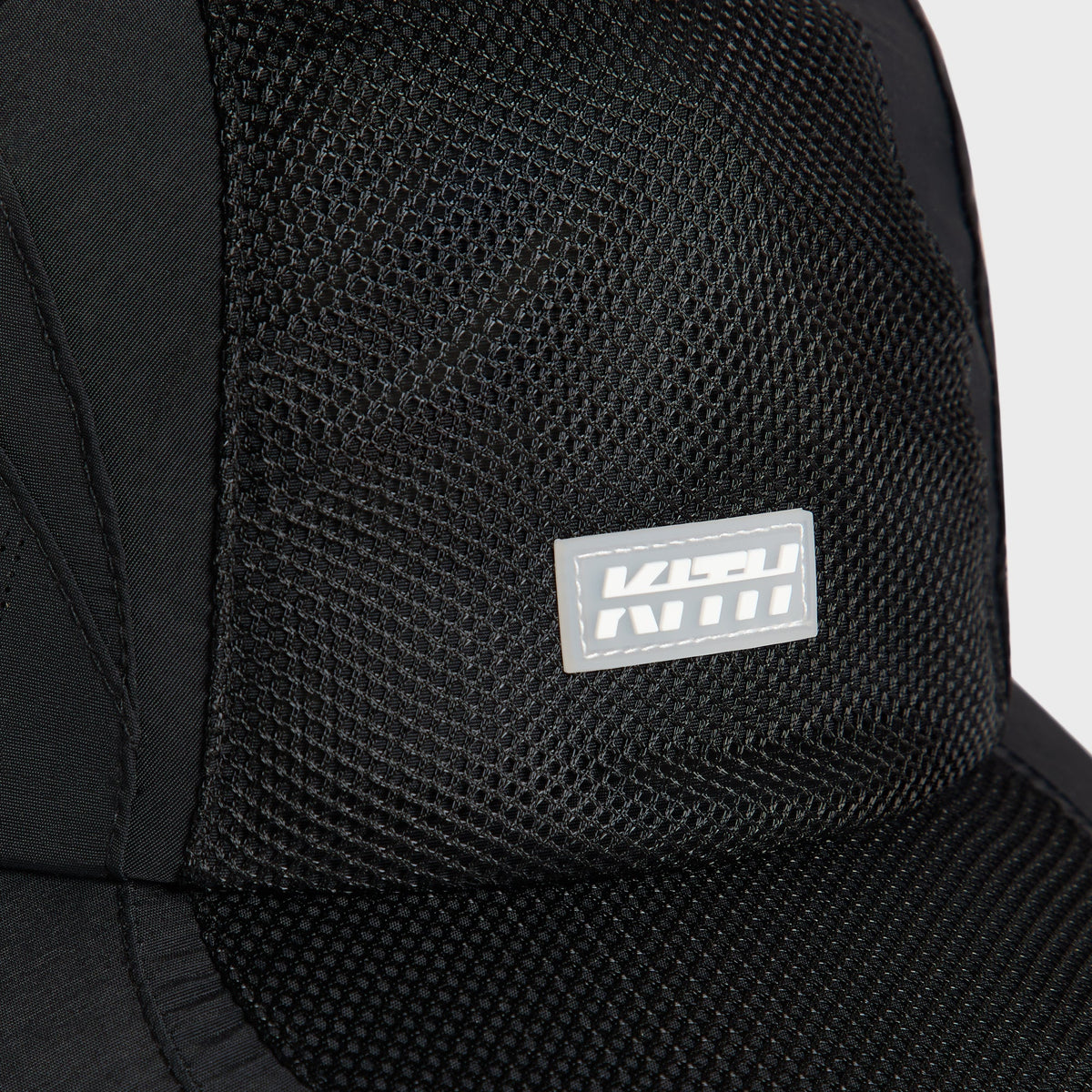 Close-up of the mesh crown panel and rubberized Kith logo patch on the Griffey Camper Hat