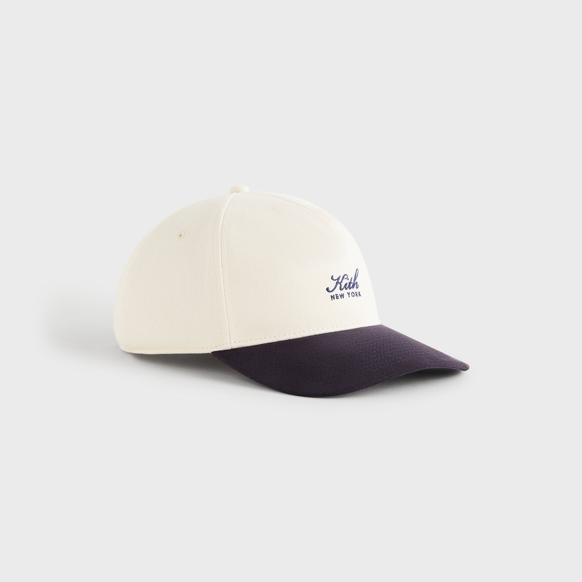 Kith Script Brushed Twill Bay Low Pinch Crown Cap in Nocturnal, three-quarter side view of pinch crown and brim