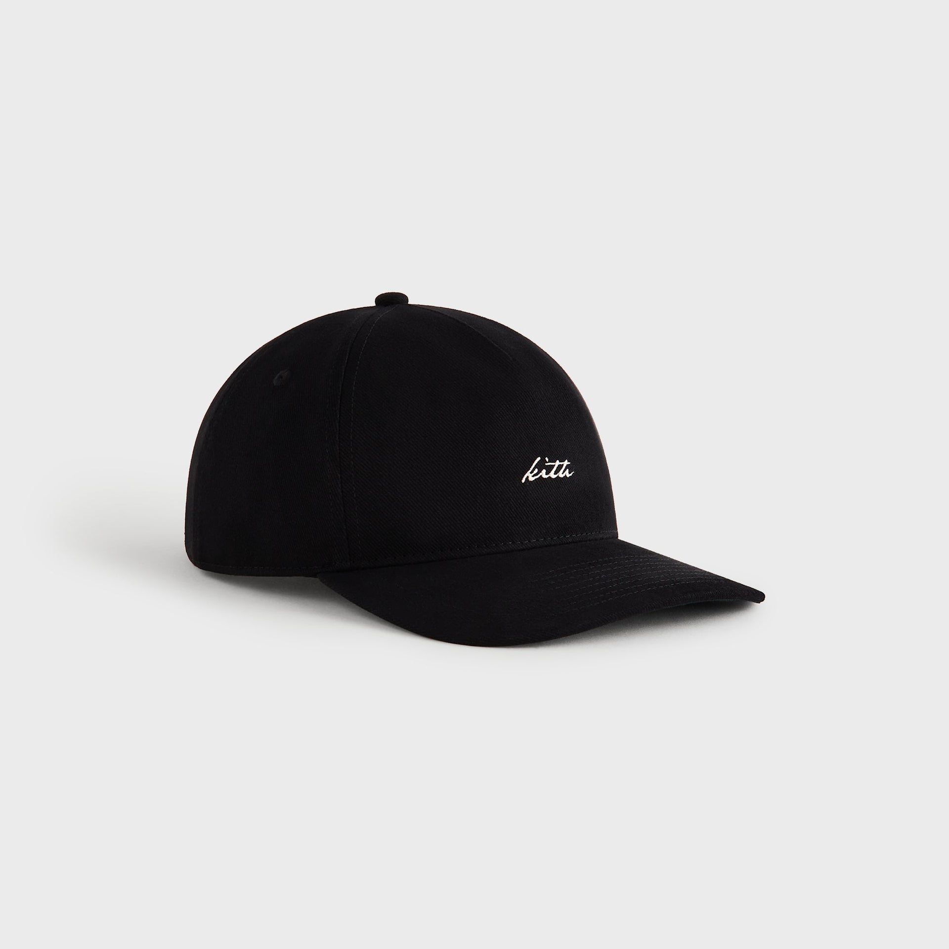 Three-quarter side angle of Kith Autograph Brushed Twill Bay Low Pinch Crown Cap in black with curved brim