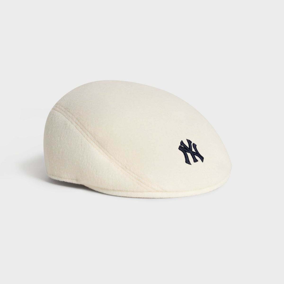 Kith & '47 Double-Face Wool Drivers Cap in Sandrift, side angled view showing embroidered NY logo