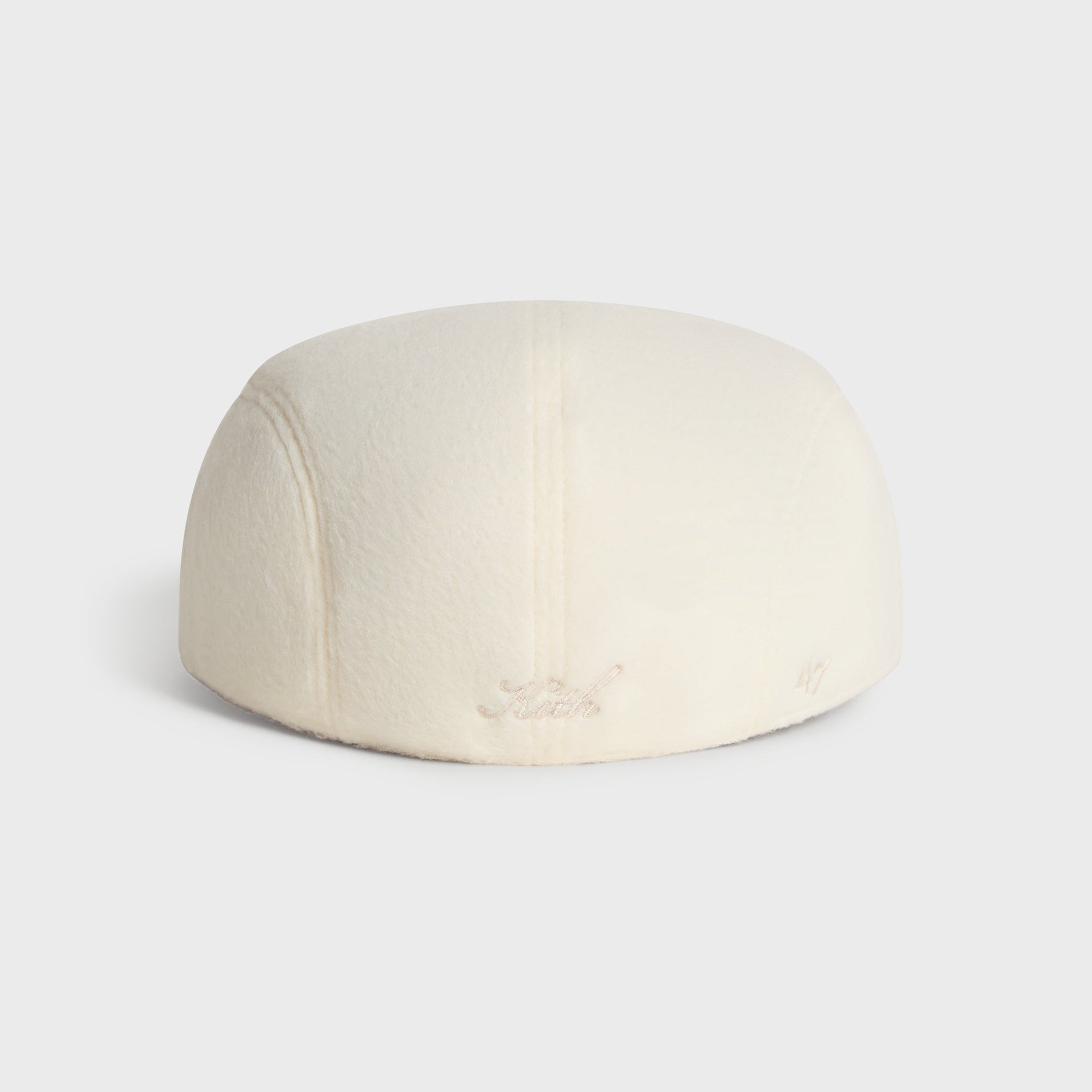 Kith & '47 Double-Face Wool Drivers Cap in Sandrift, rear angle with Kith script and 47 logo near brim