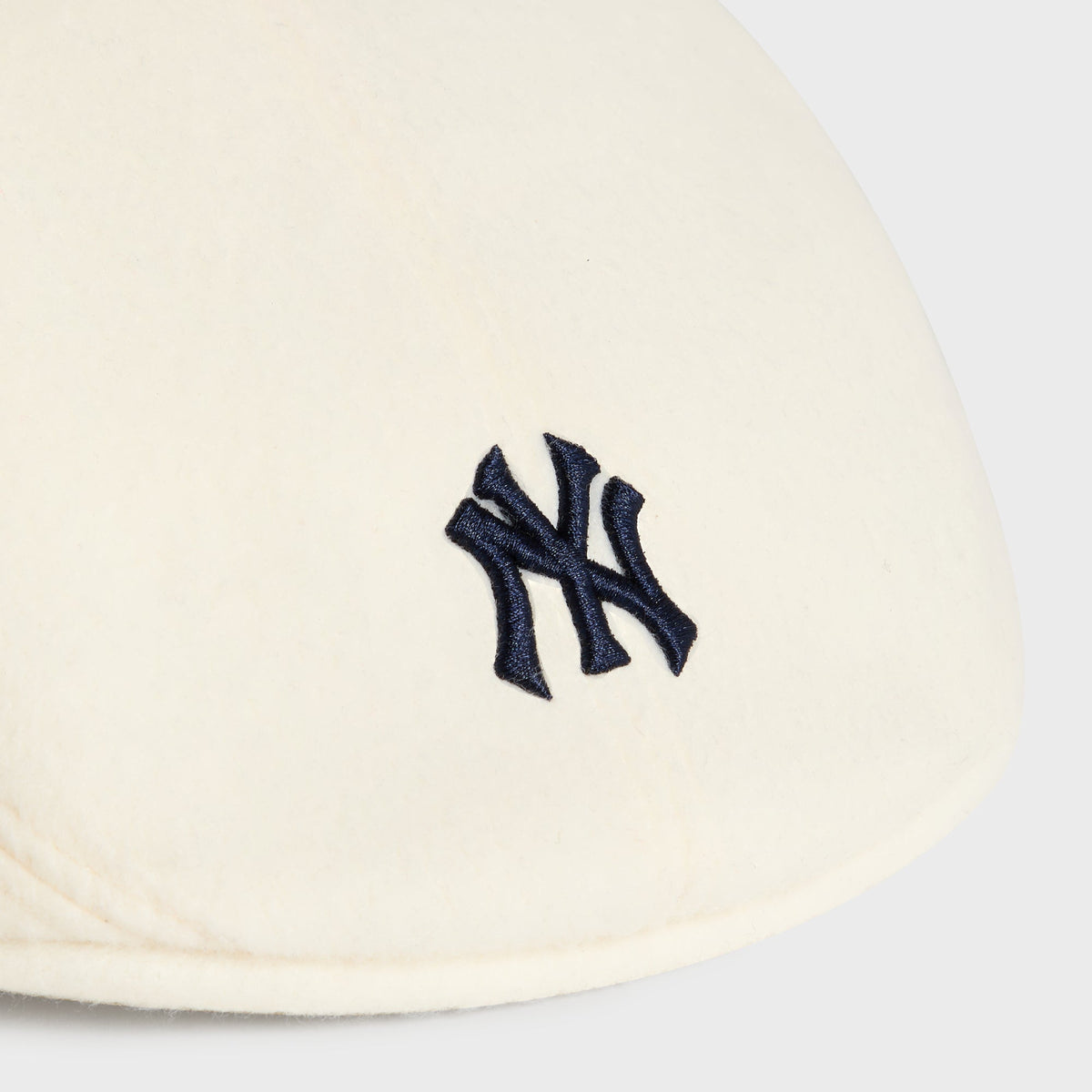 Close-up of embroidered NY logo on Sandrift Double-Face Wool Drivers Cap