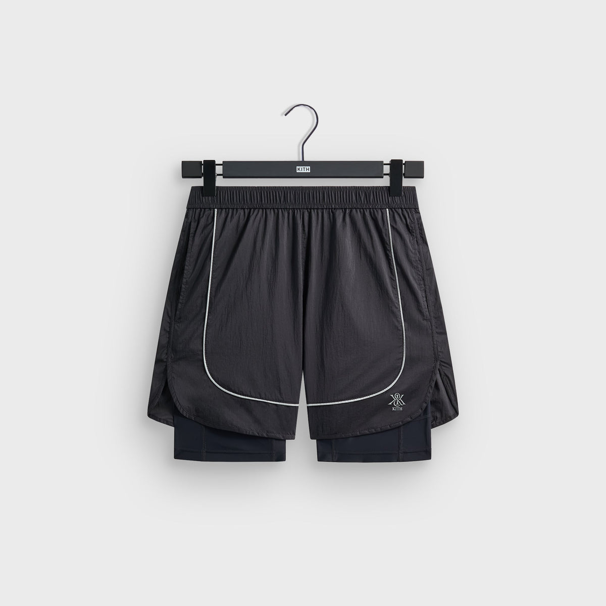 Kith Jordan 5-inch Tech Short in charcoal with built-in compression liner, white piping and Kith crest logo, flat lay front