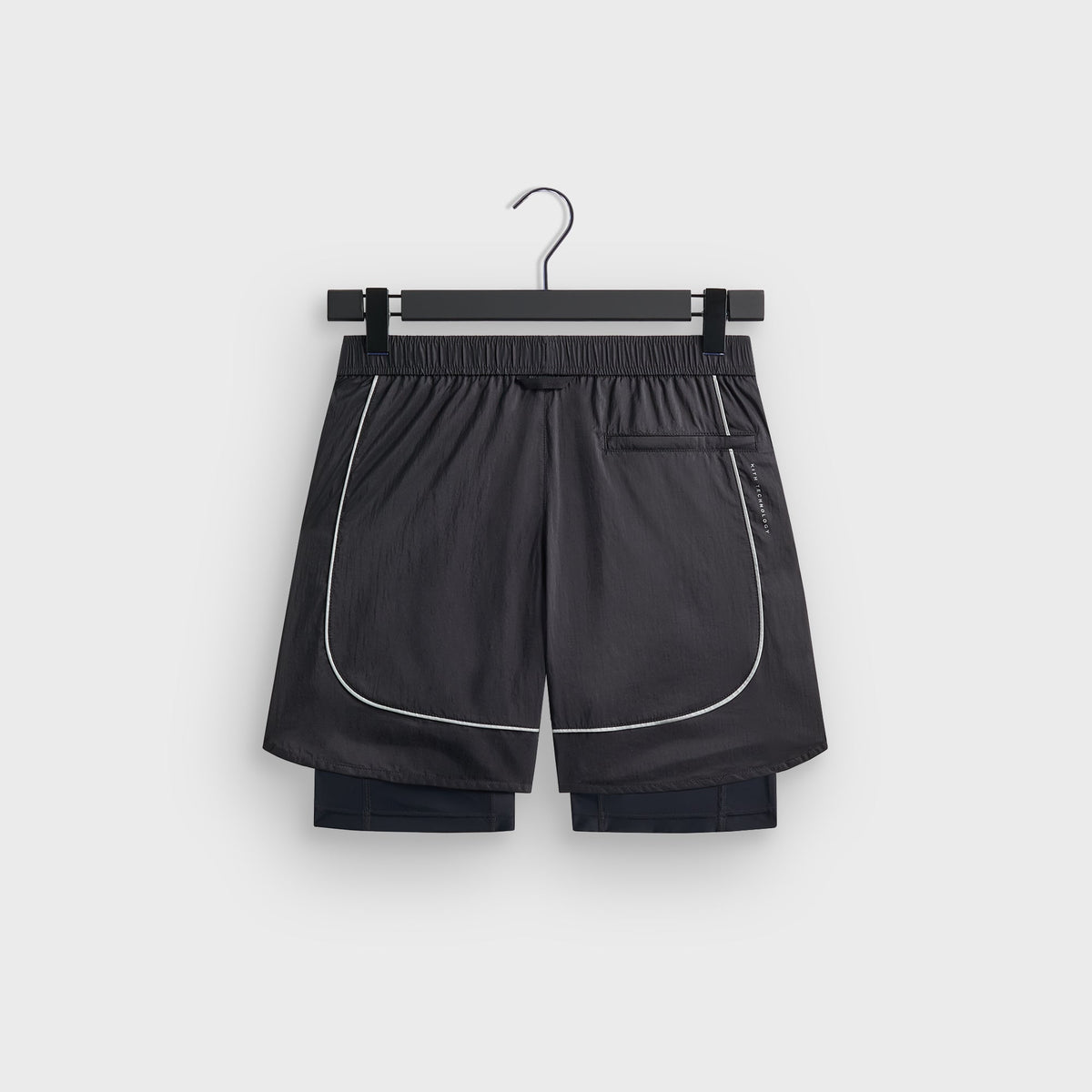 Kith Jordan 5-inch Tech Short in charcoal, flat lay back view with zip pocket and Kith Technology text