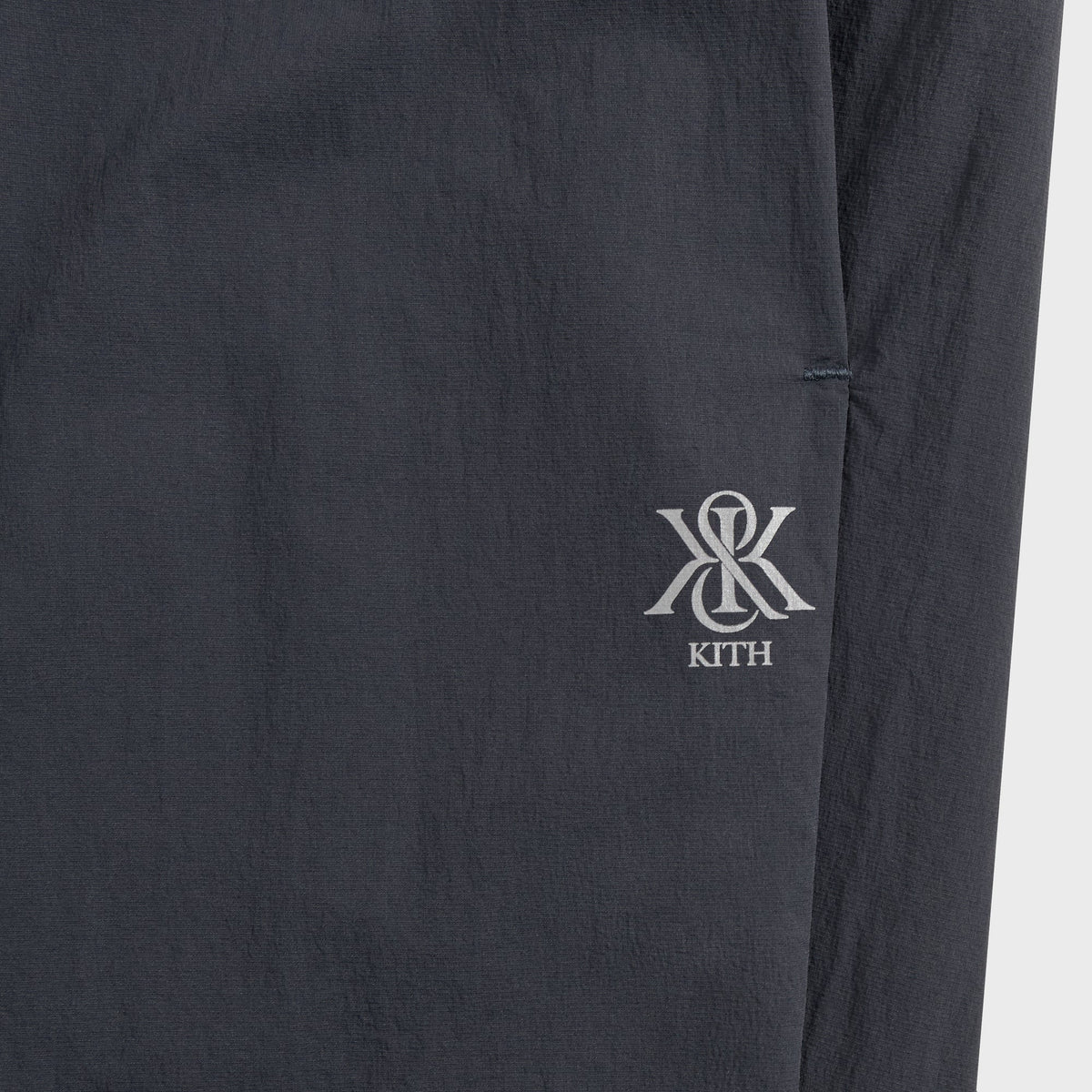 Close-up of Kith Four-Way Stretch Idris Pant side pocket with embroidered Kith crest logo