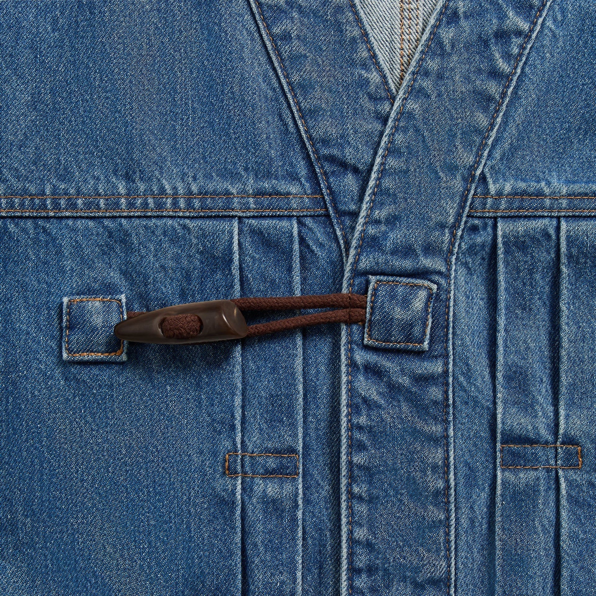 &Kin Clint Trucker Jacket detail, brown leather toggle-and-loop closure across the V-neck denim placket, River Indigo