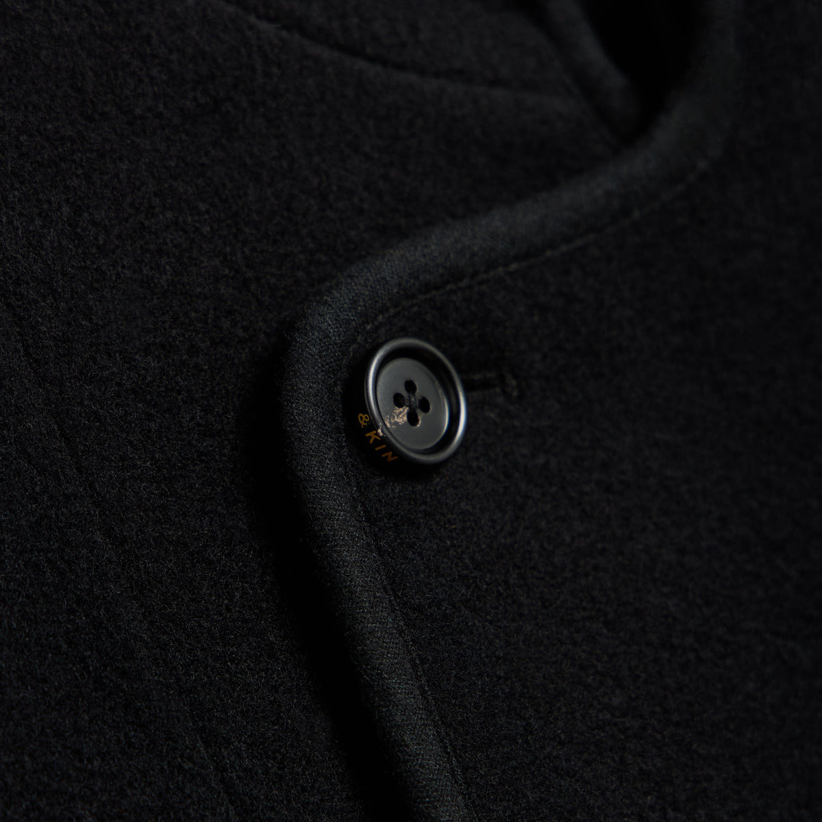 Close-up of a black button on the &Kin Wool Cashmere Bowie jacket