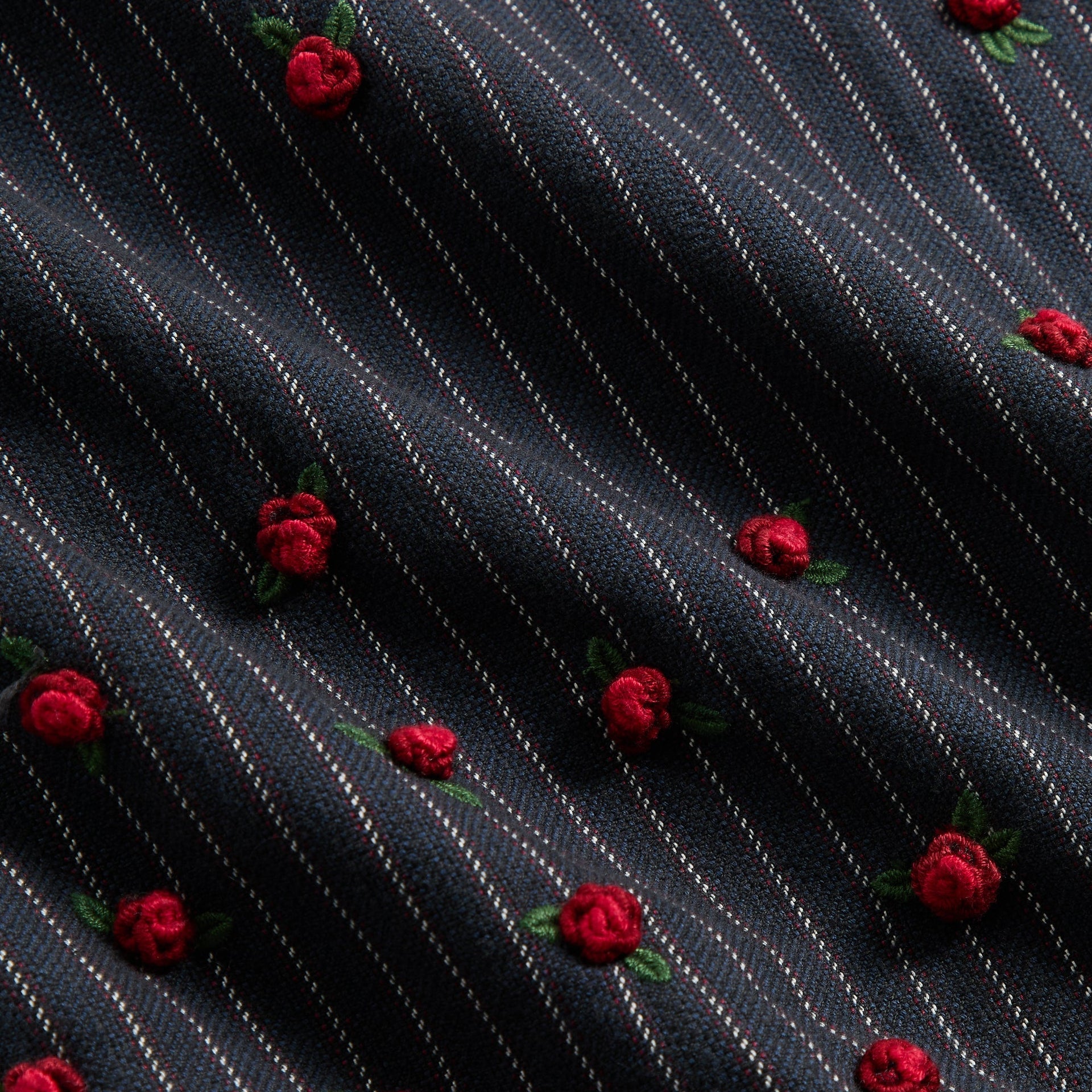 &Kin Embellished Alistair Jacket fabric close-up, navy pinstripe with raised red rosebud embroidery
