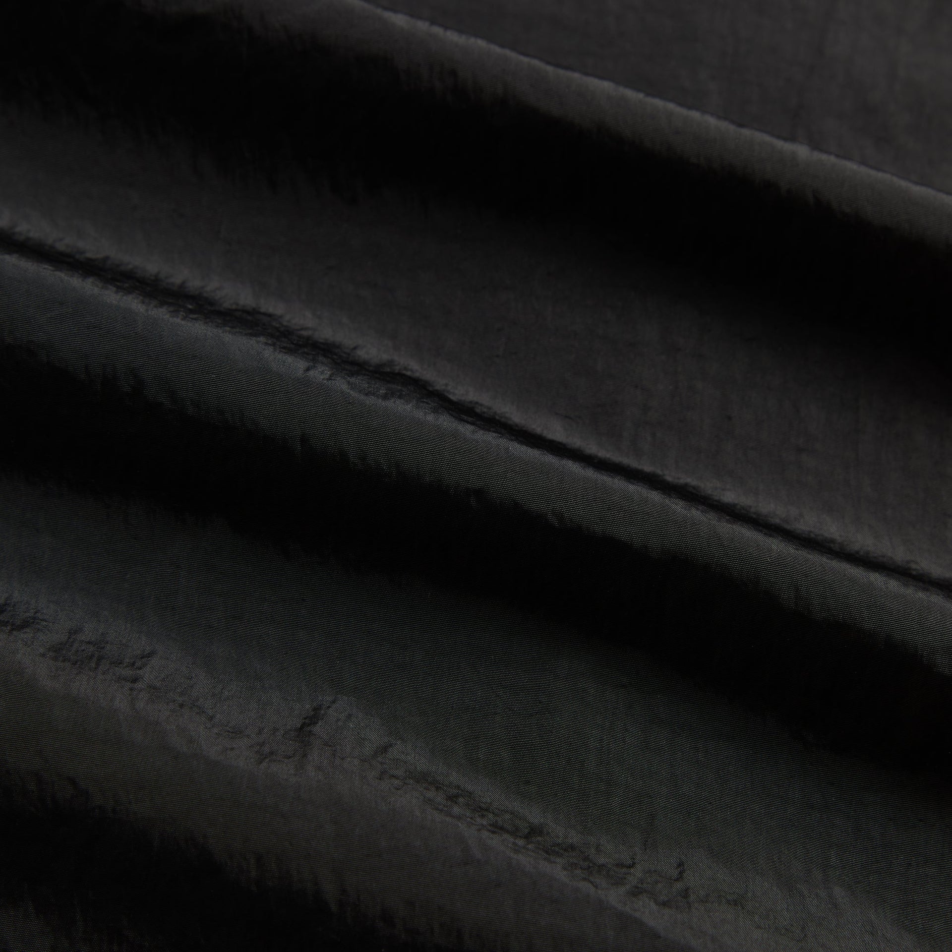 Close-up of the black nylon shell fabric texture on the Kith Bolt jacket