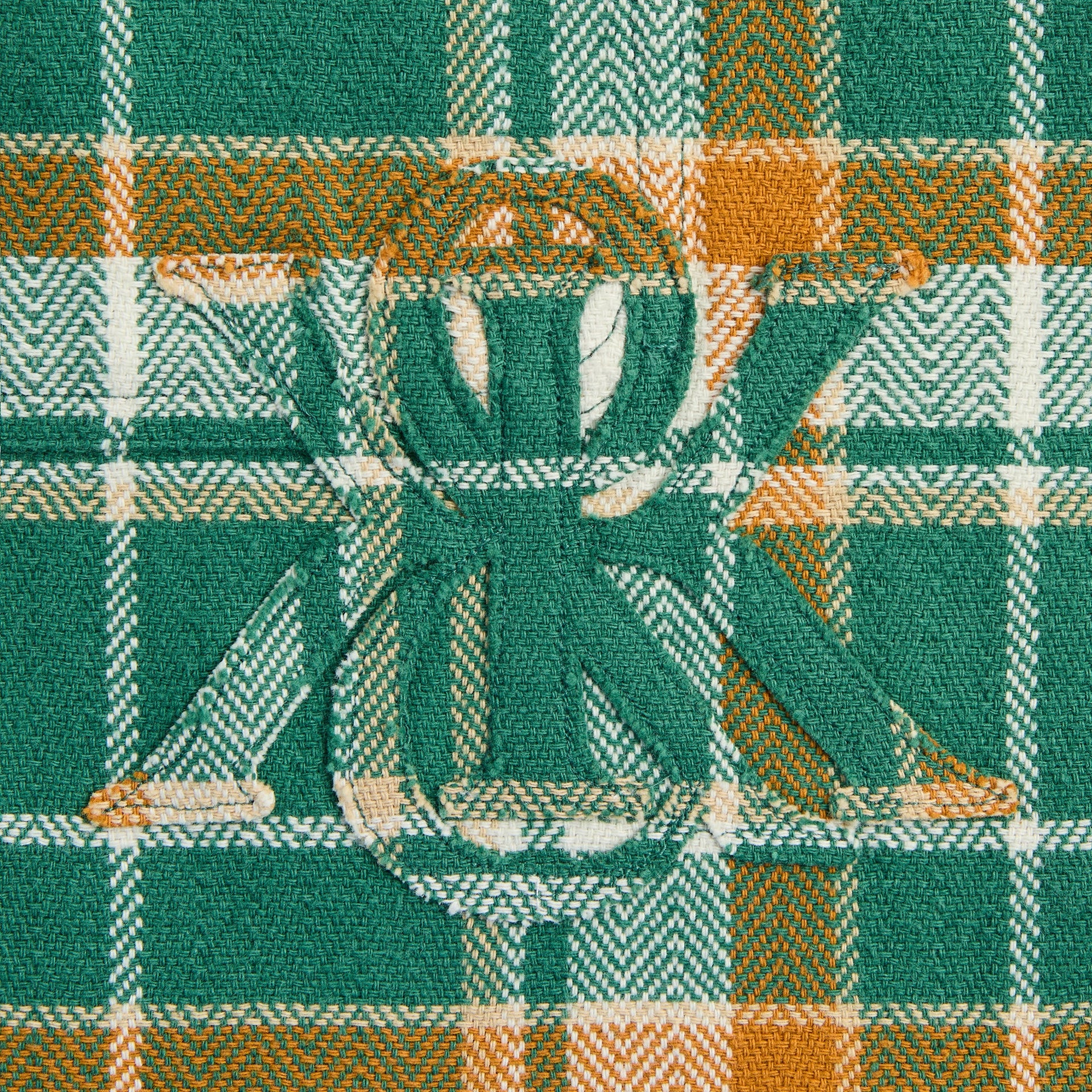 Close-up of the embroidered ampersand K logo on the Kith Plaid Henson buttondown shirt in alpine plaid