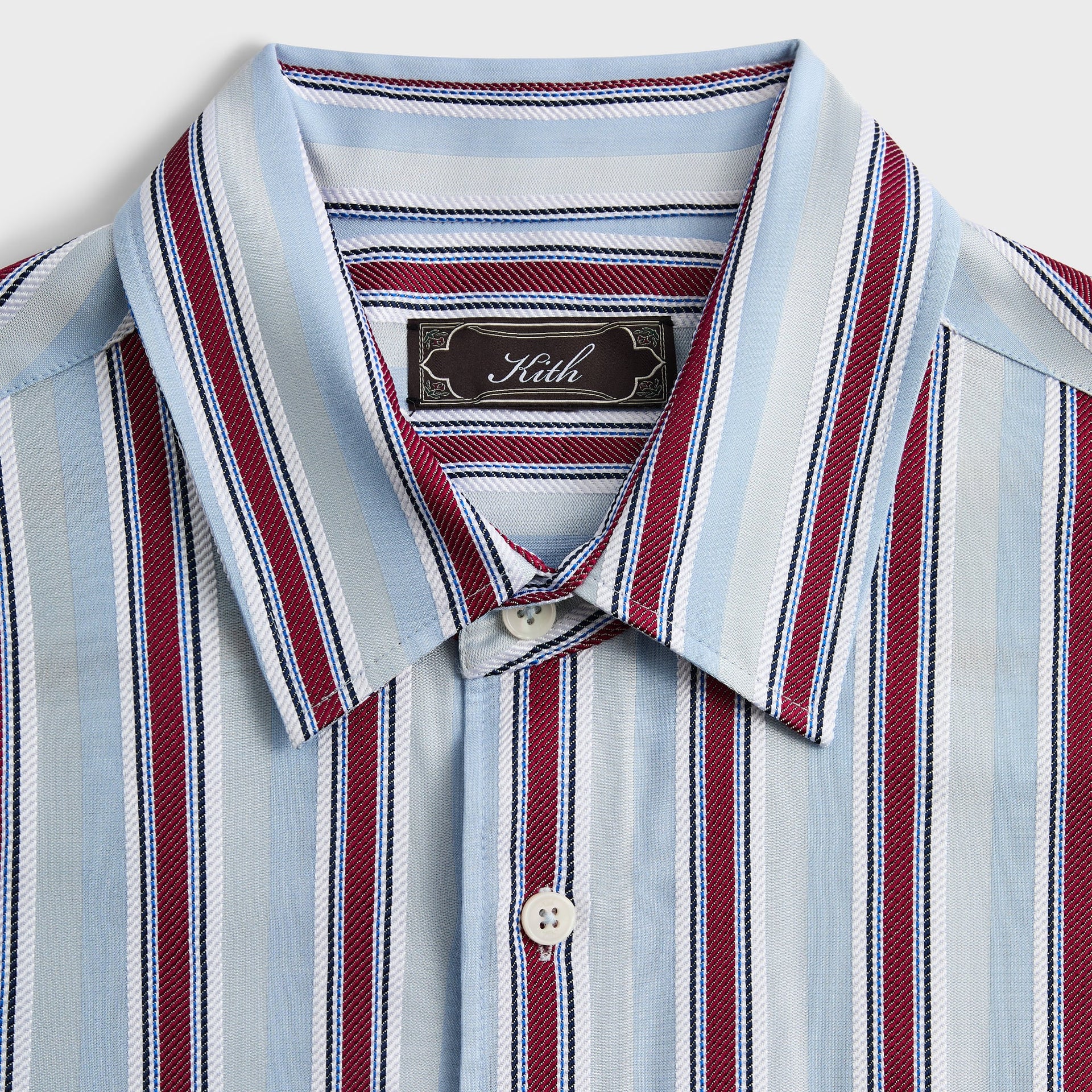 Close-up of the collar and woven Kith label on the Striped Jacquard Thompson shirt in tin