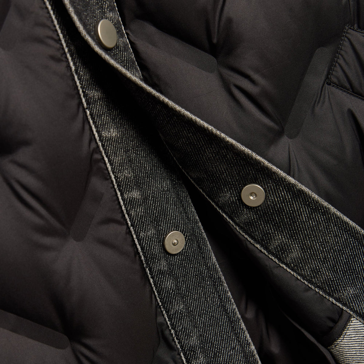 Close-up of the snap placket and denim detail on the black Quilted Denim Gertie shirt