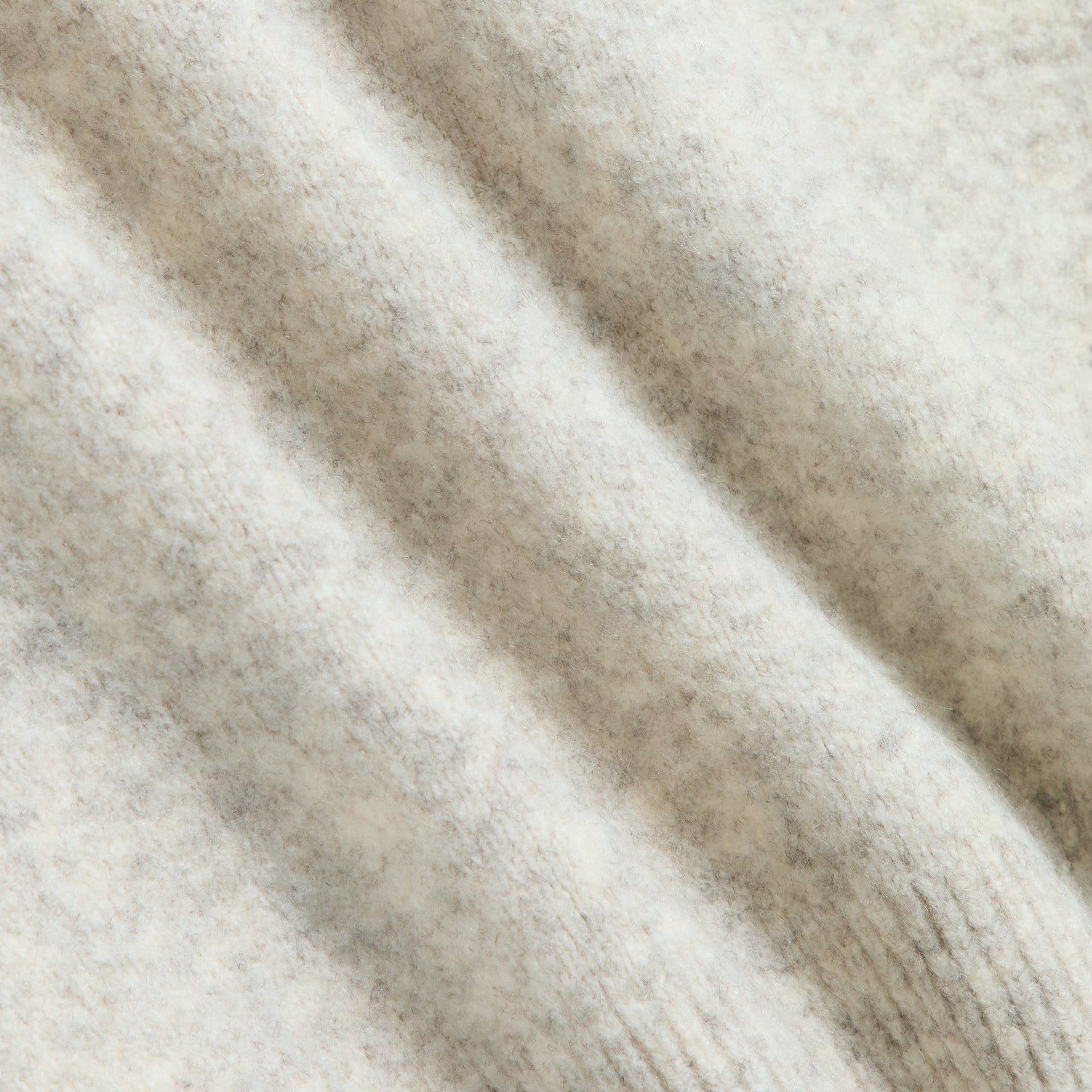 Close-up of the light heather grey boucle knit texture on the Kith Tobey polo