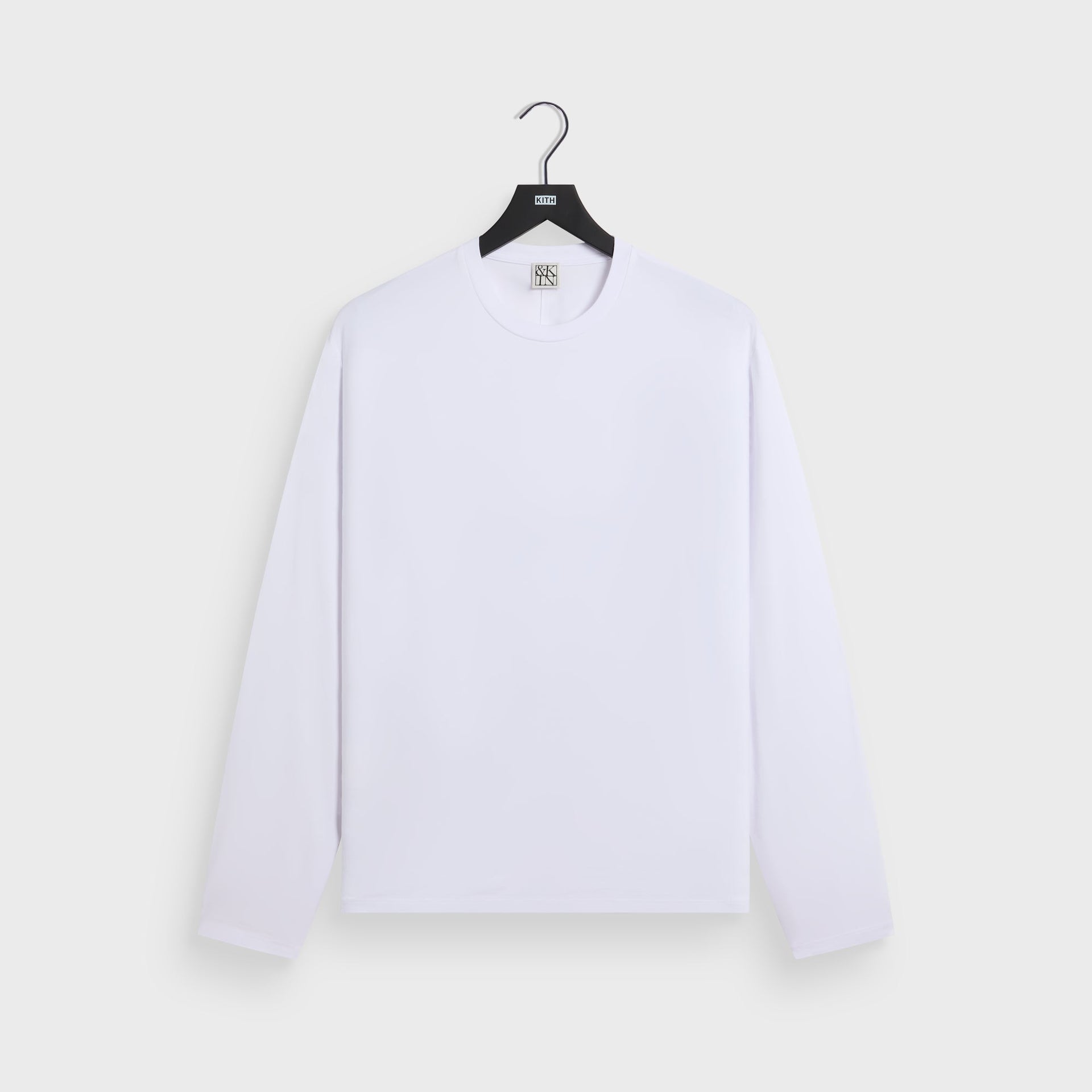 &Kin Long Sleeve Halston Tee in white, front on KITH hanger with crewneck and long sleeves