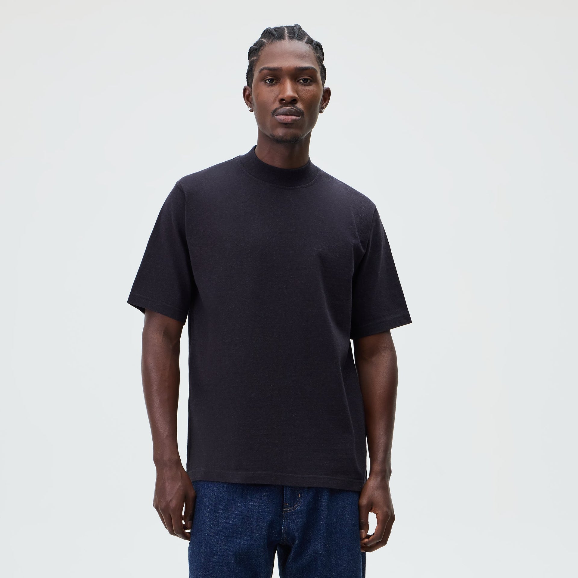 &Kin Mock Neck James Tee in washed black worn by a model with dark denim jeans, front view