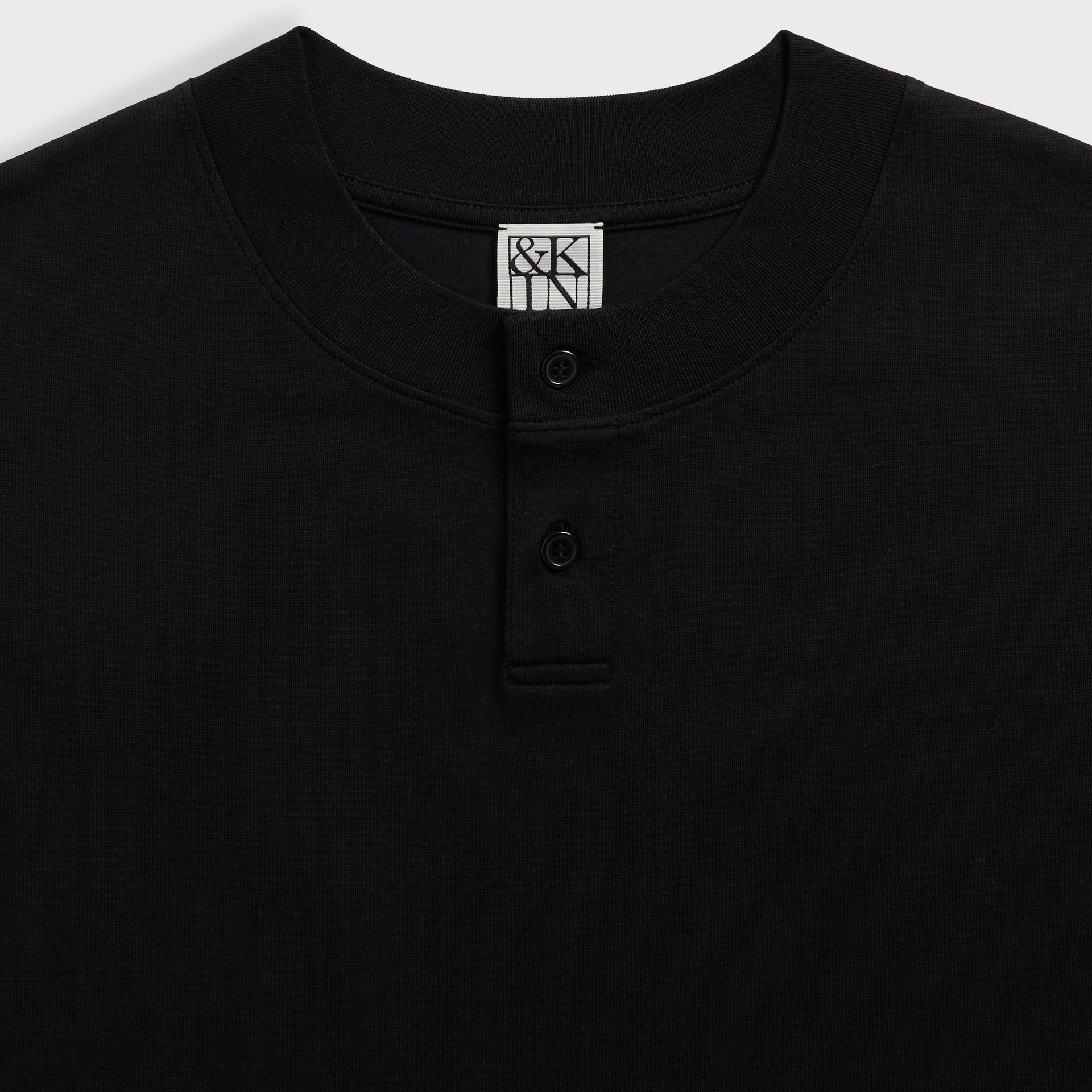 &Kin Albie Henley detail: ribbed neck with two-button placket and woven &Kin label in black