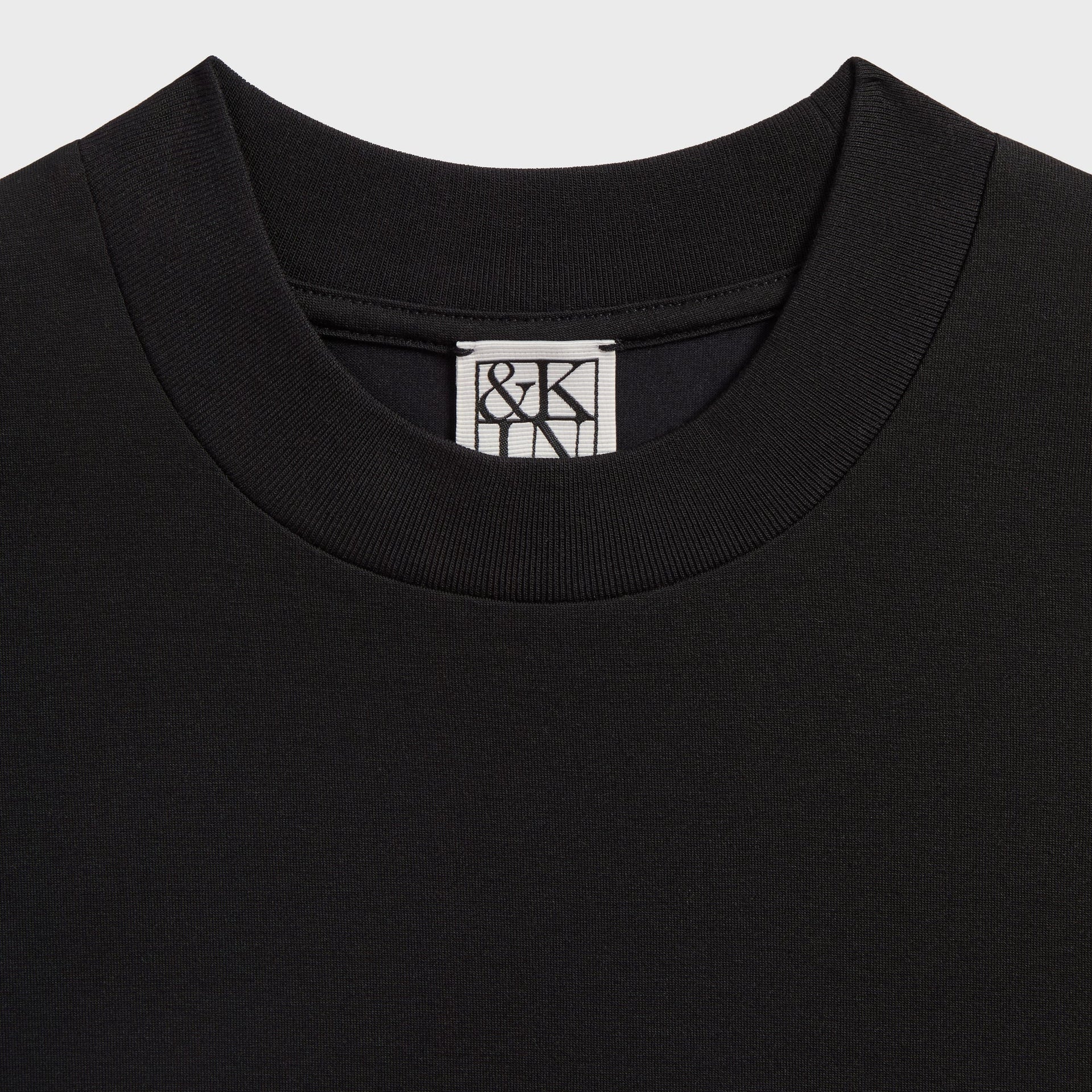 &Kin Albie Tee detail, ribbed black mock neck collar with woven &Kin logo label