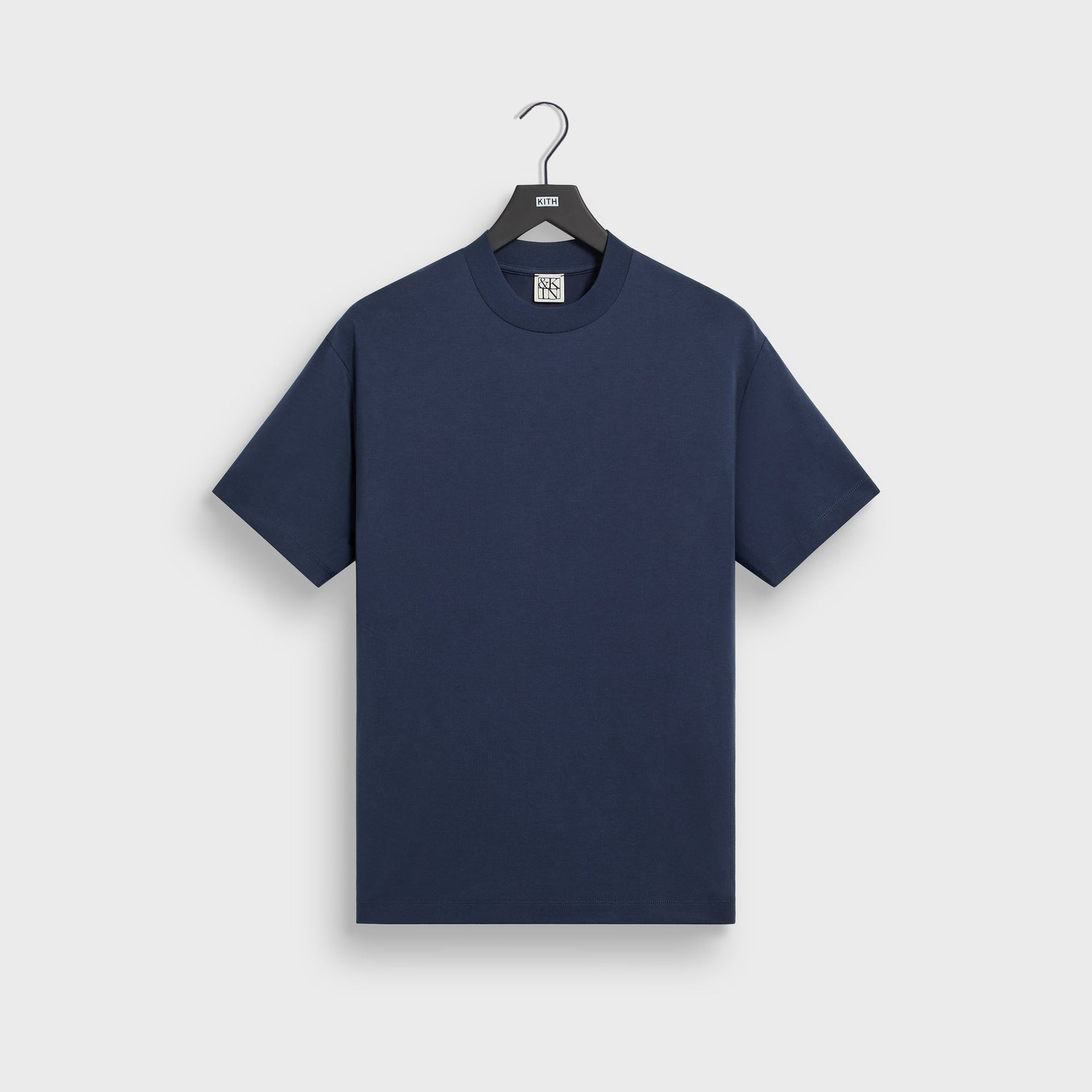 &Kin Mock Neck Albie Tee in Nocturnal navy, front on KITH hanger with ribbed mock neck and short sleeves